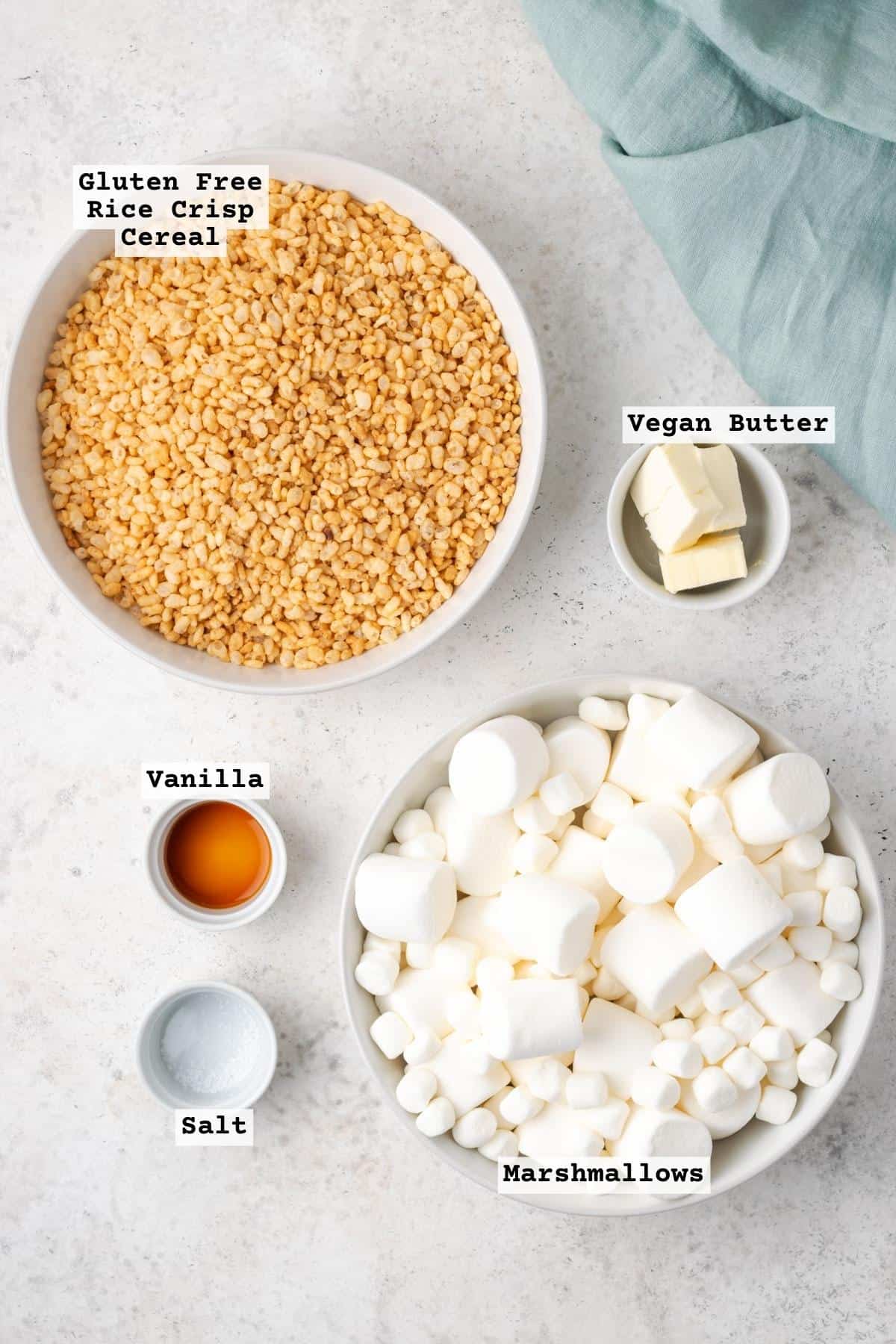 Ingredients for gluten free rice krispie treats on a white table. 