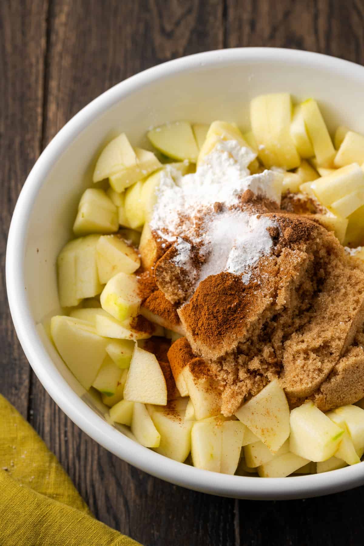 Cut apples, brown sugar, lemon juice, cornstarch, salt, cinnamon, nutmeg and vanilla combined in a large mixing bowl. 