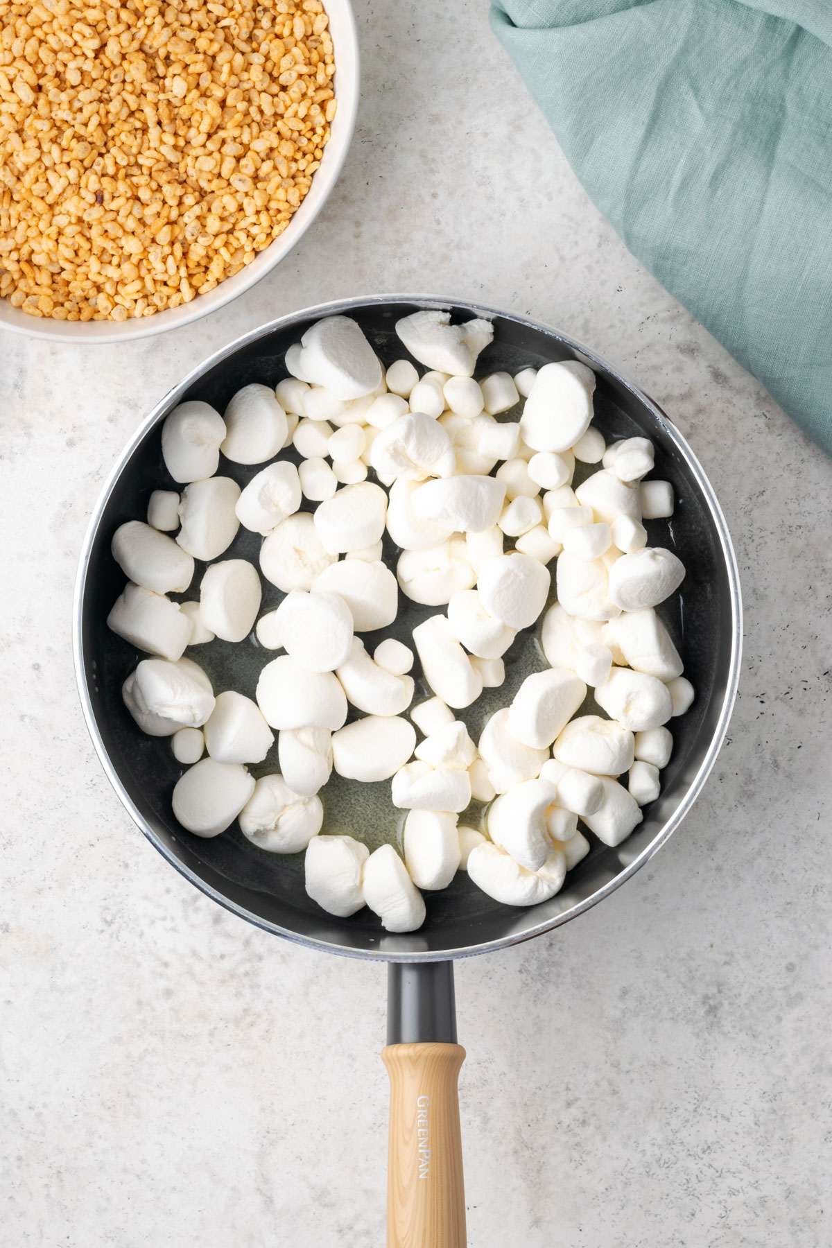 Marshmallows being melted with butter in a large saucepan.