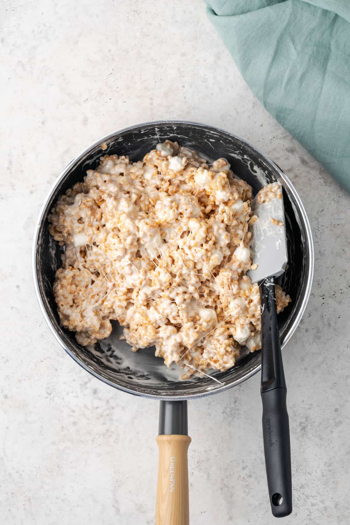 Mixed rice krispie treat batter in a large saucepan.