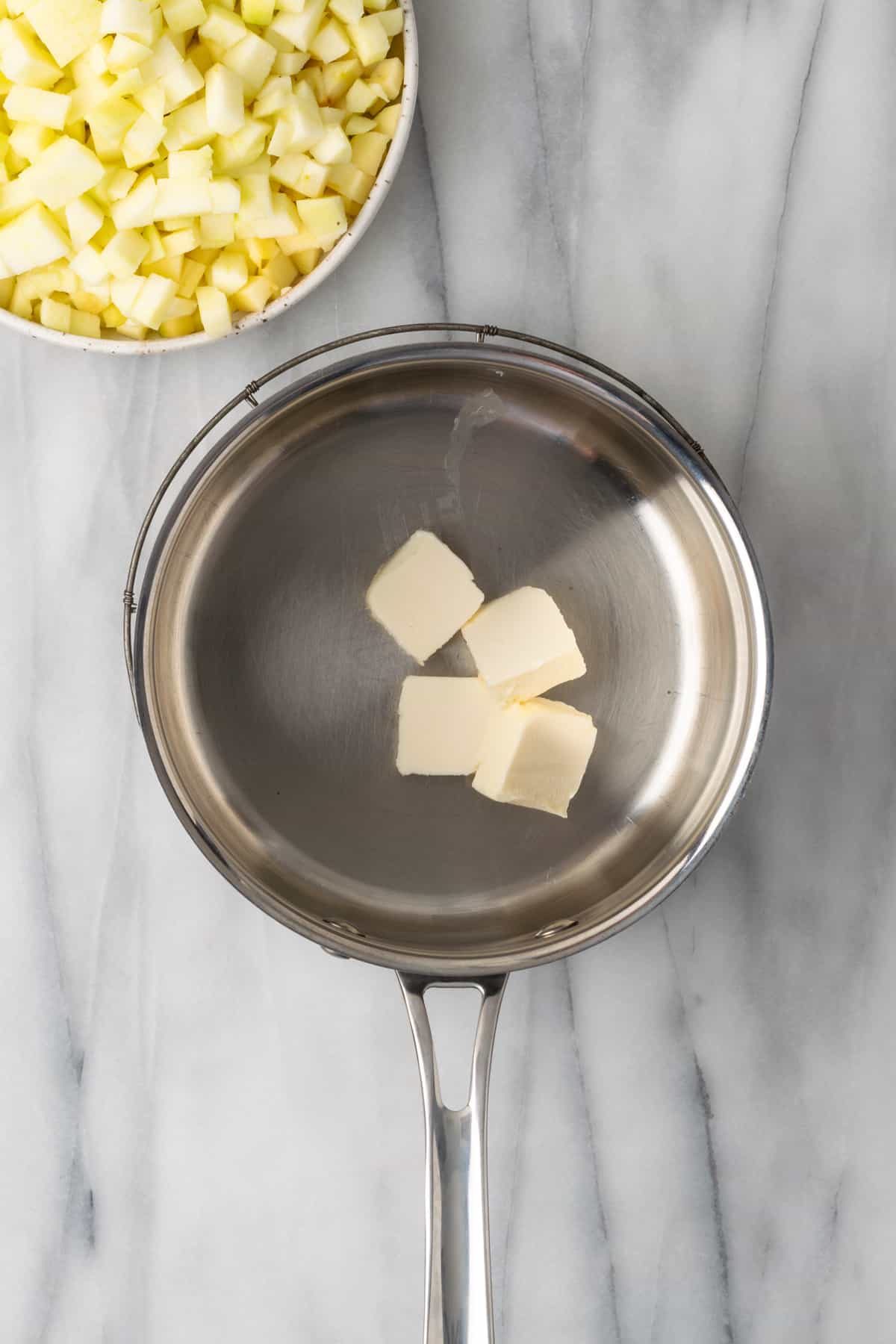 Butter melting in a metal saucepan.