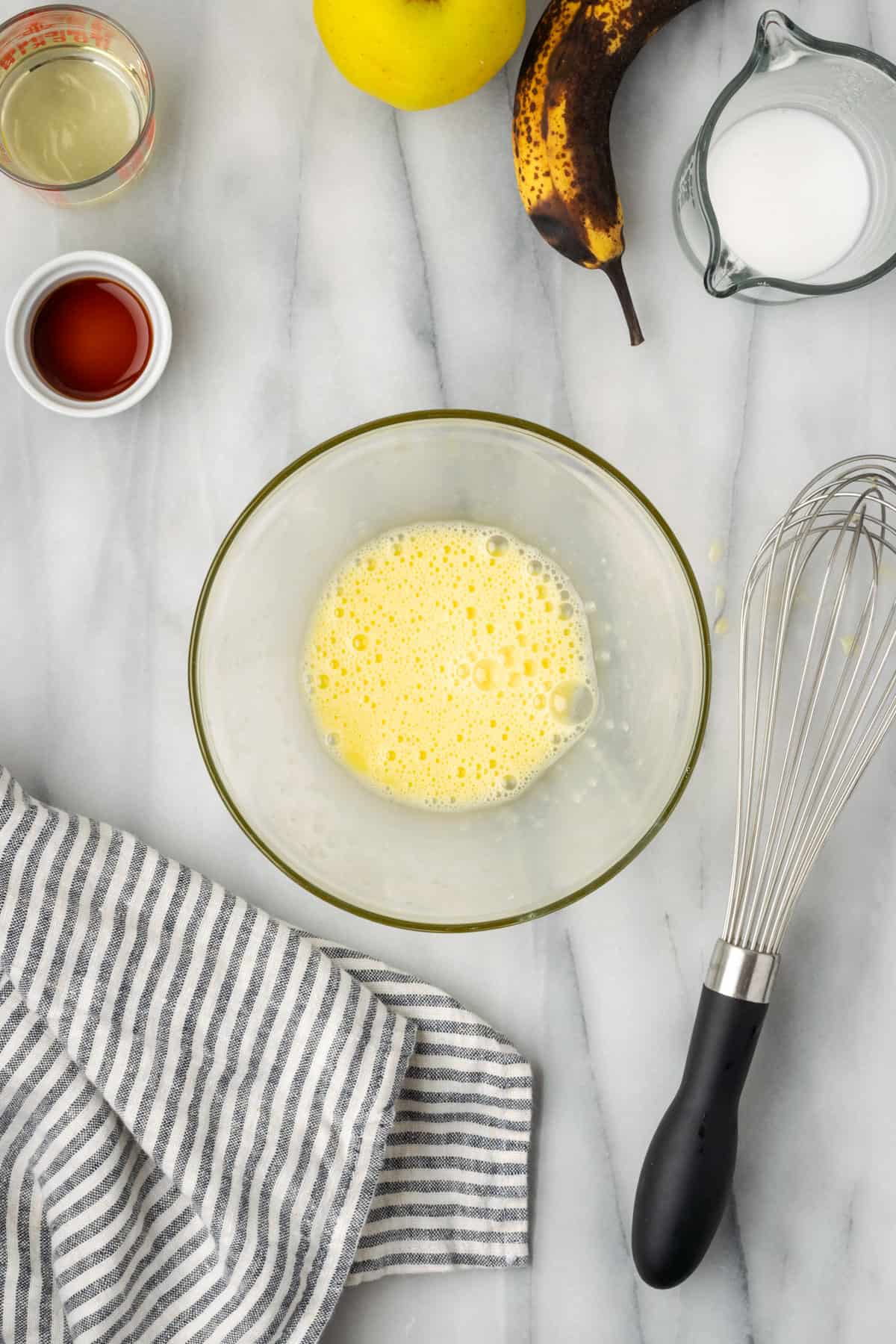 A beaten egg in a small mixing bowl.