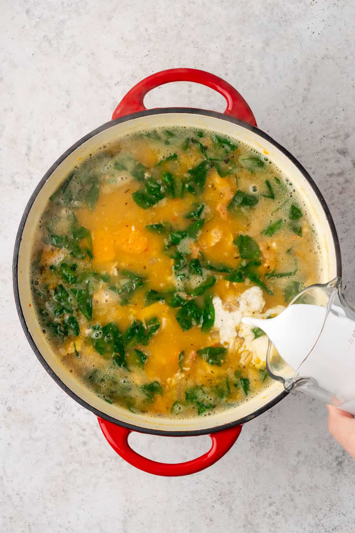 Cream being poured into the finished soup.