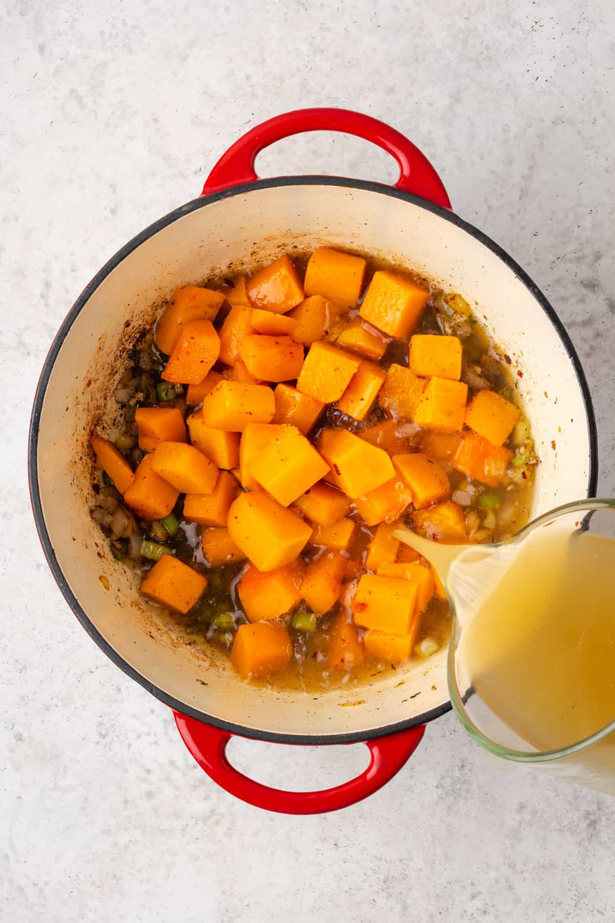 Squash and chicken broth added to the dutch oven pot.