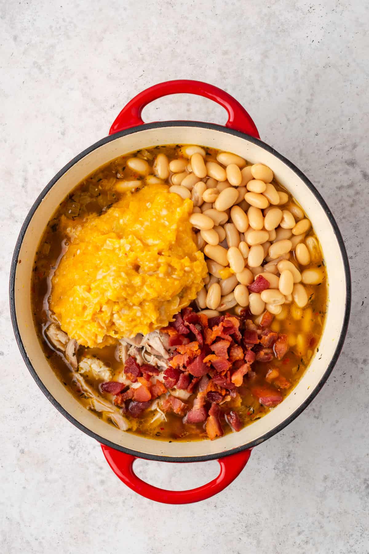 Chicken, mashed squash, beans and bacon added to the soup pot.