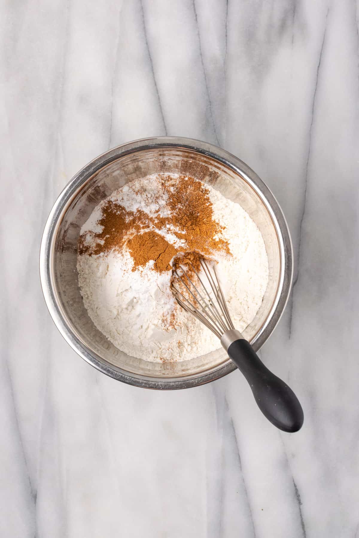 Gluten free flour, baking powder, pumpkin pie spice, cinnamon and salt combined in a small bowl.