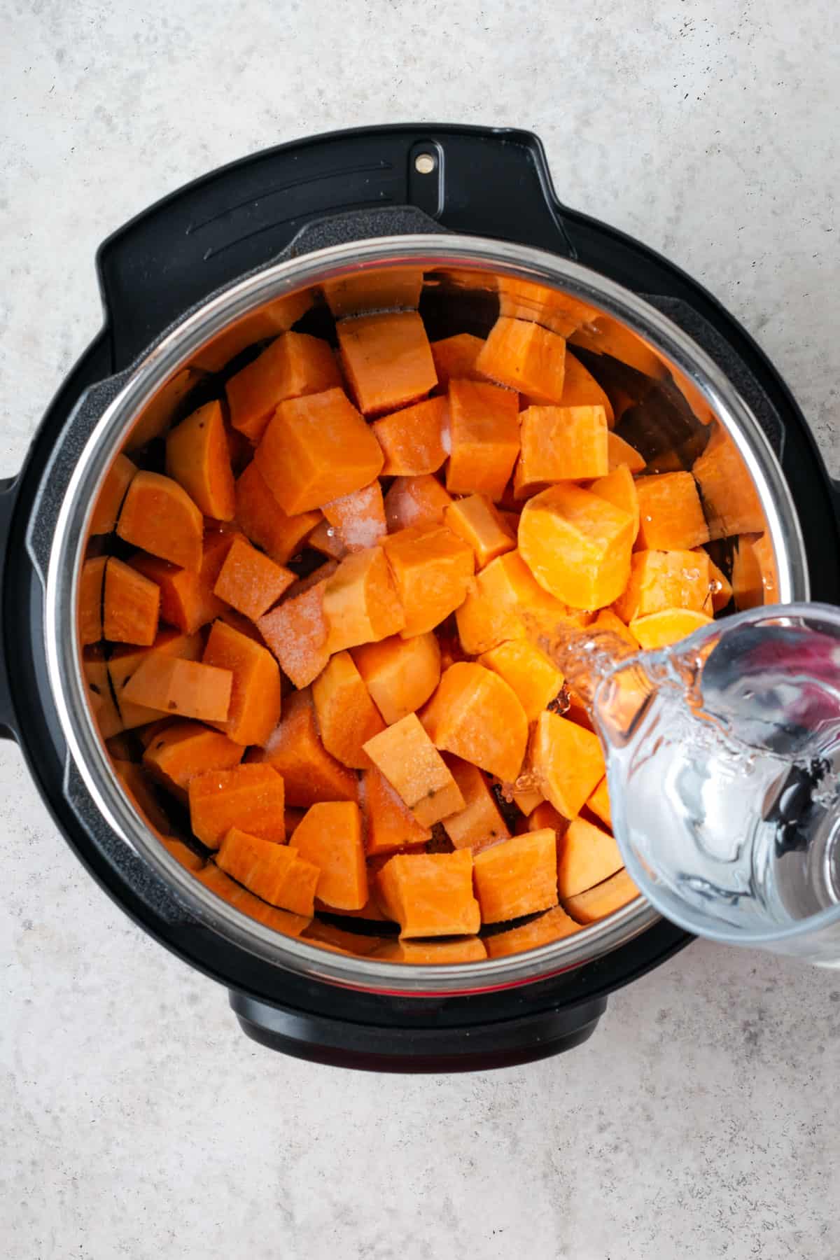 Sweet potatoes and water inside in Instant Pot.