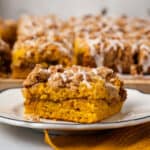 A slice of pumpkin coffee cake on a white plate.
