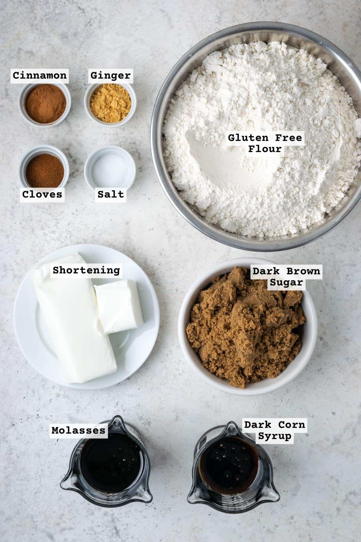Ingredients for gluten free gingerbread house on a white table.