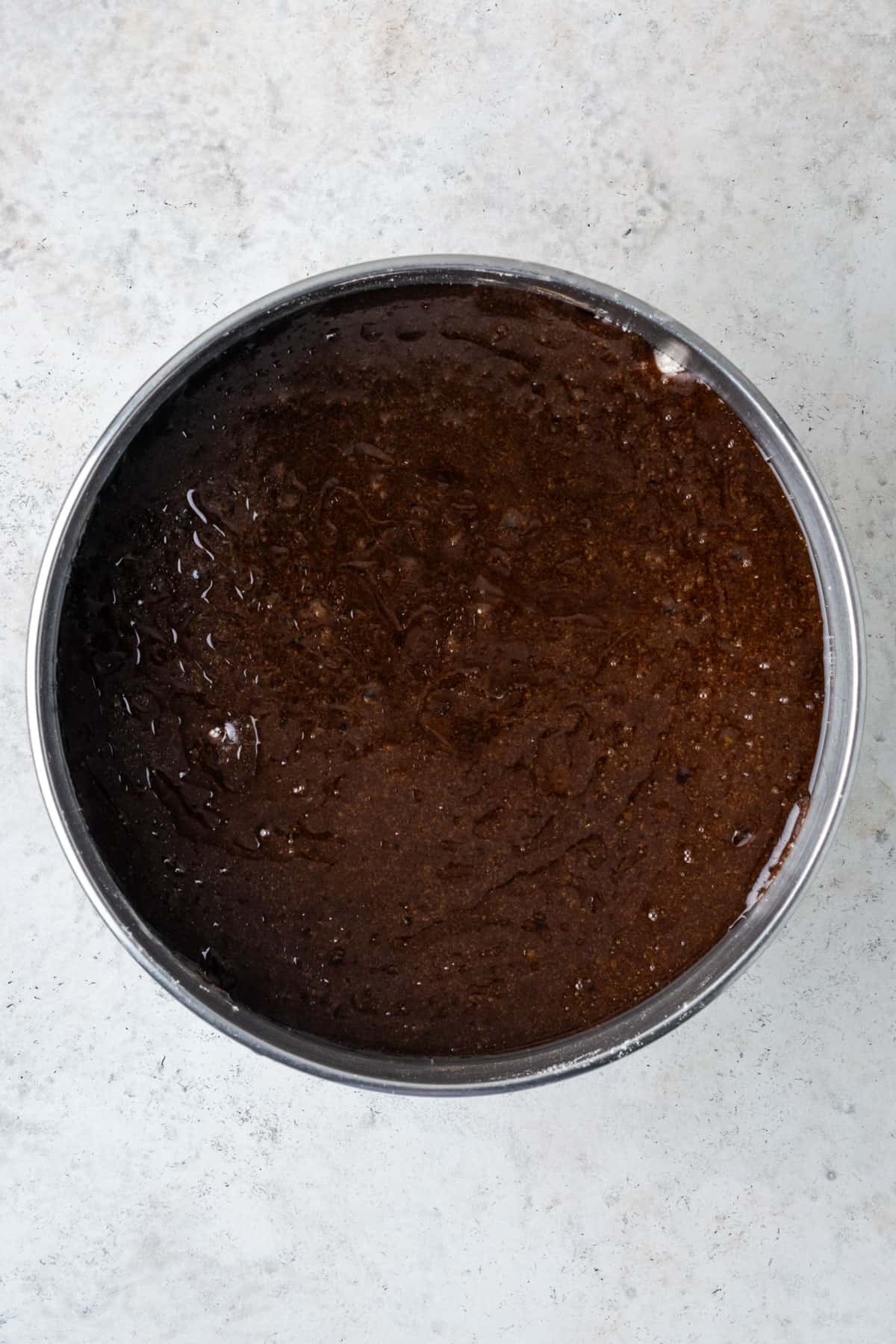 Dark sugar mixture poured into the bowl with the dry ingredients.