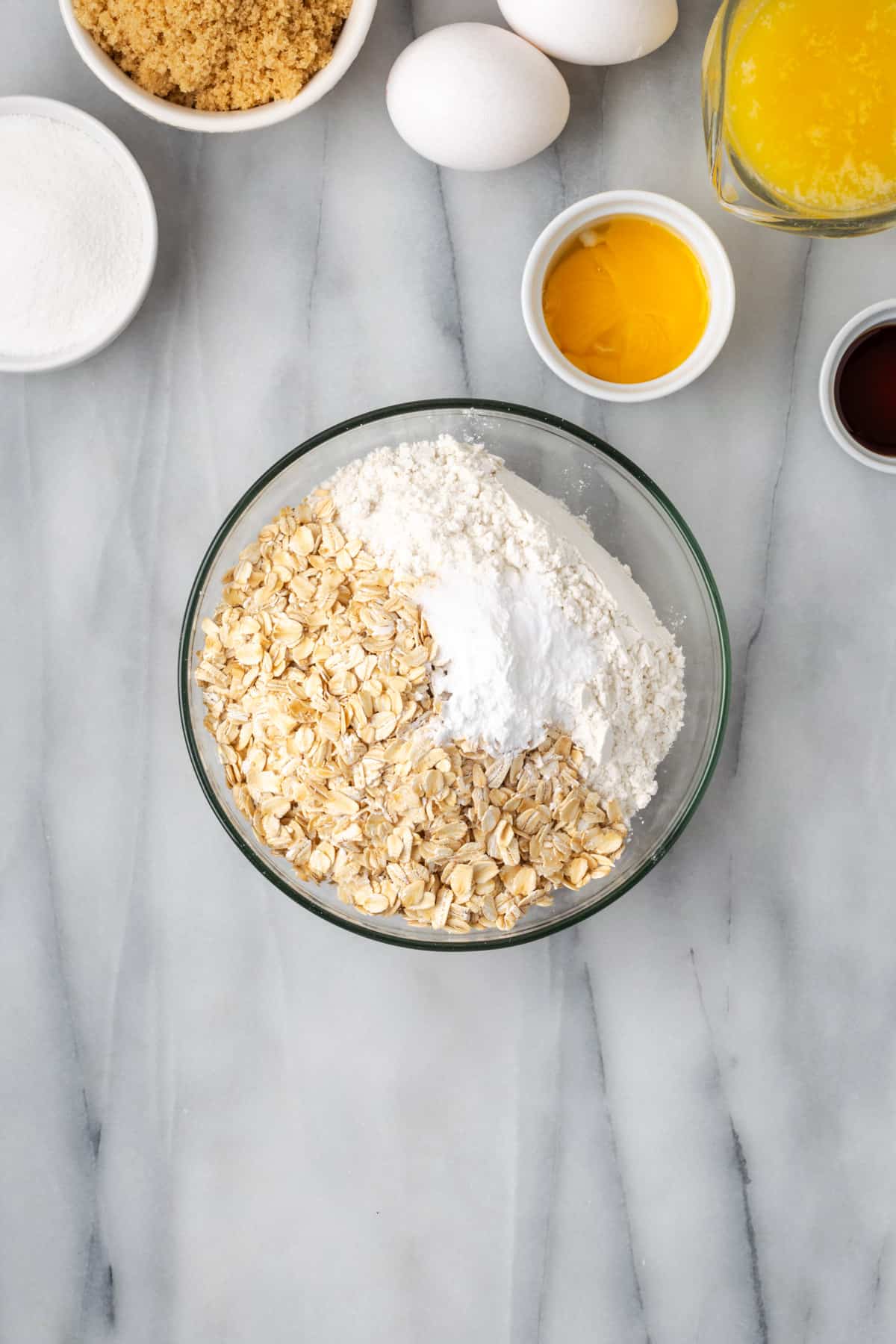 Gluten free flour, oats, baking powder, baking soda and salt combined in a mixing bowl. 