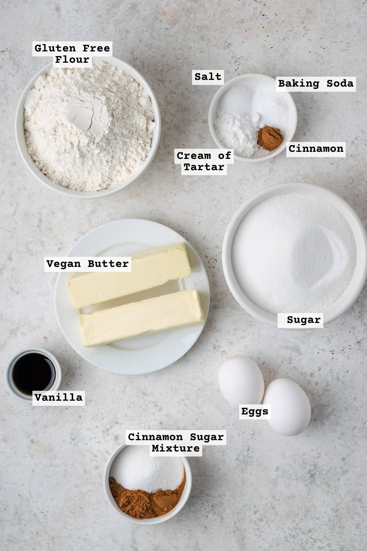 Ingredients for gluten free snickerdoodle cookies on a white table. 