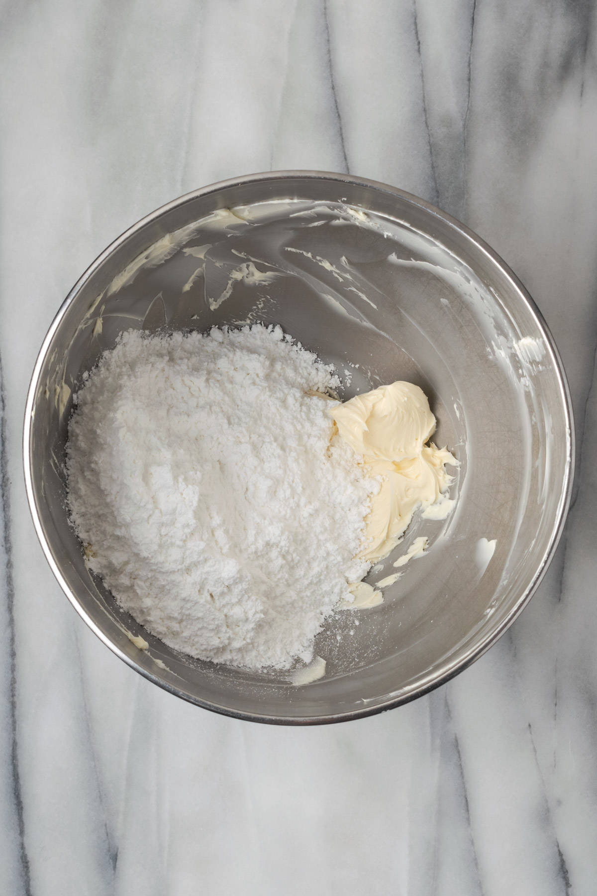 Sifted powdered sugar added into the butter. 