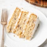A slice of Italian cream cake served on a white plate.