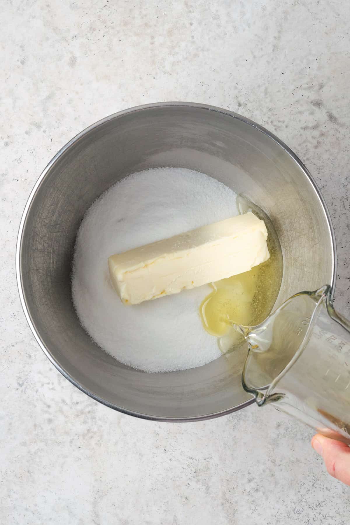 Butter, sugar and oil combined together in a large mixing bowl. 