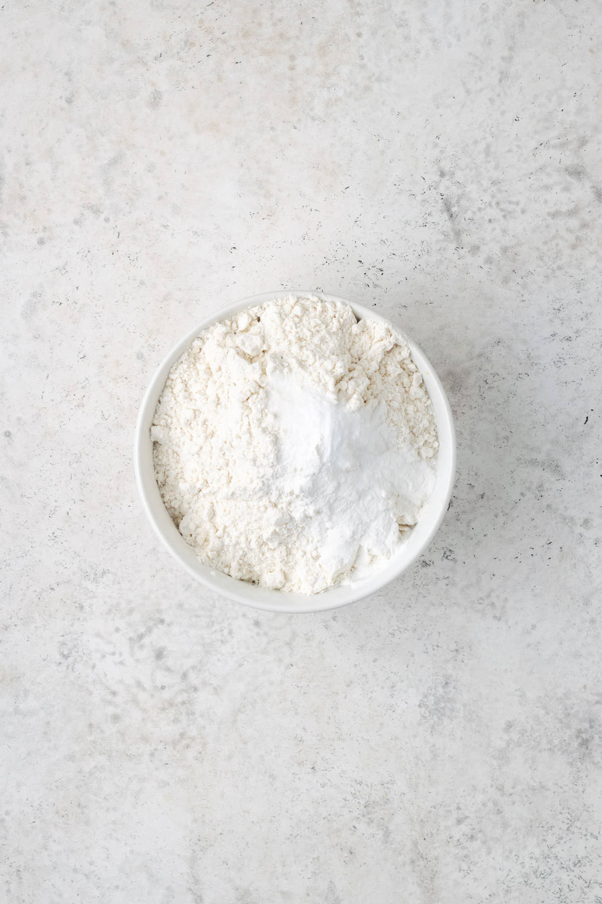 Gluten free flour, baking powder, baking soda and salt combined in a small mixing bowl.