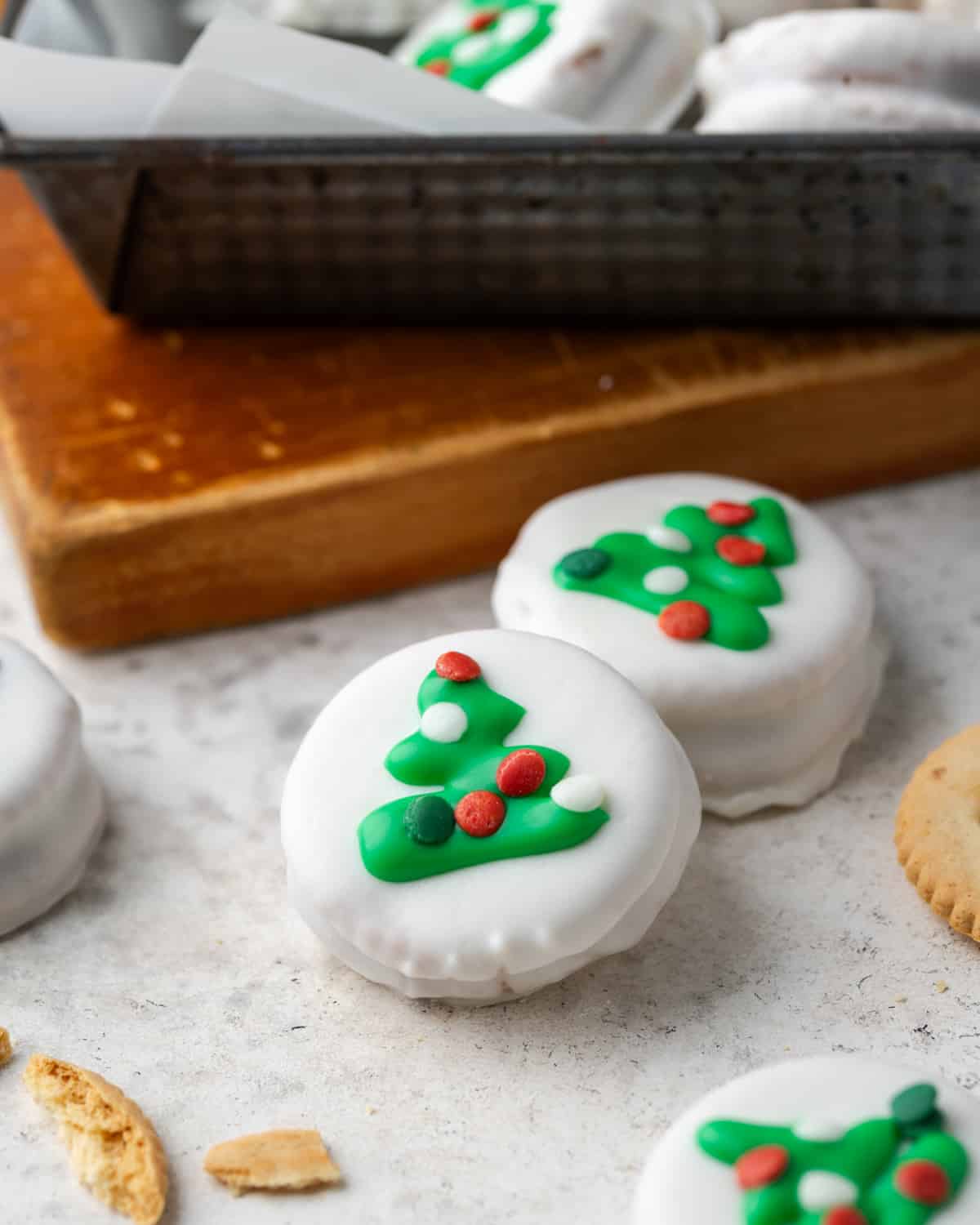 White chocolate Ritz cracker cookies decorated with Christmas trees and sprinkles. 