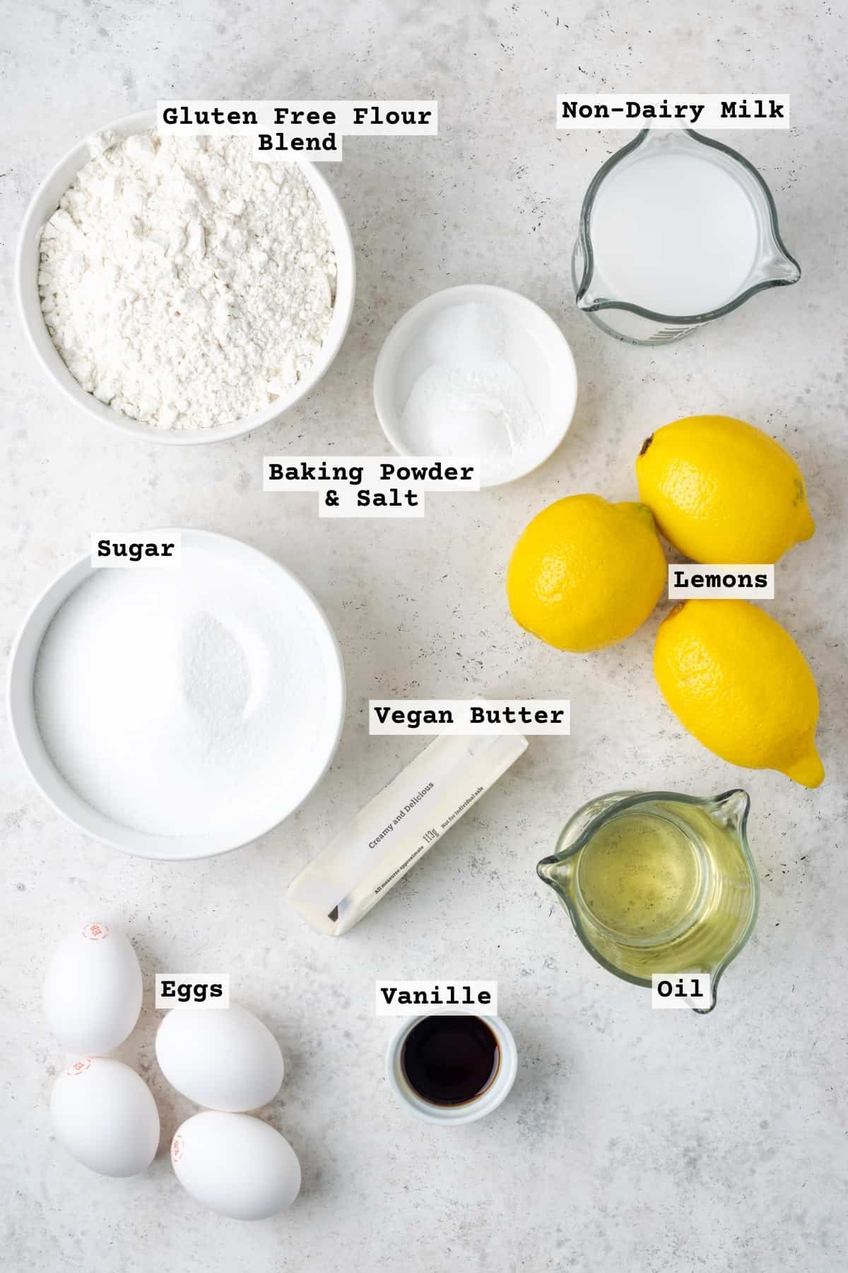 Ingredients for gluten free lemon cake on a white table. 