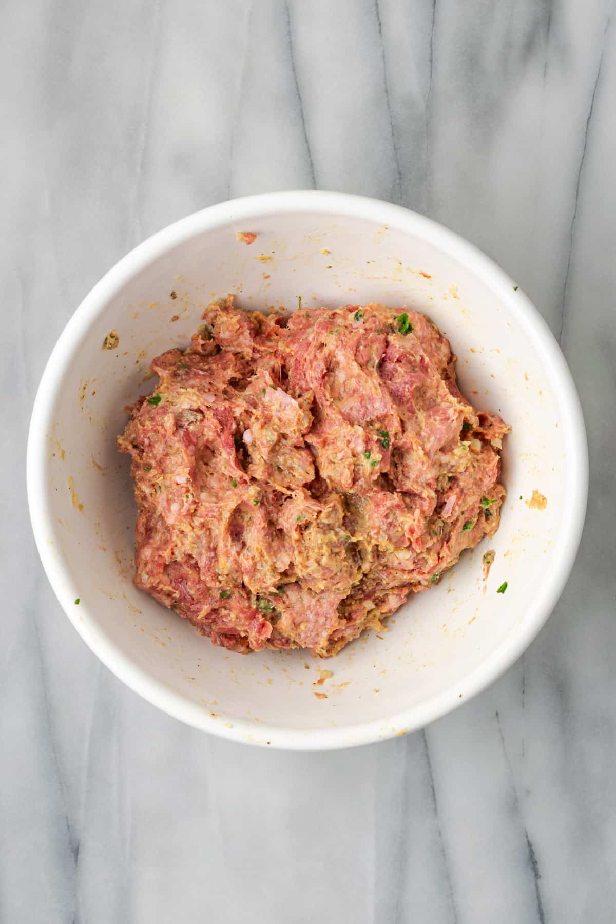 Gluten free meatball mixture combined in a large bowl.