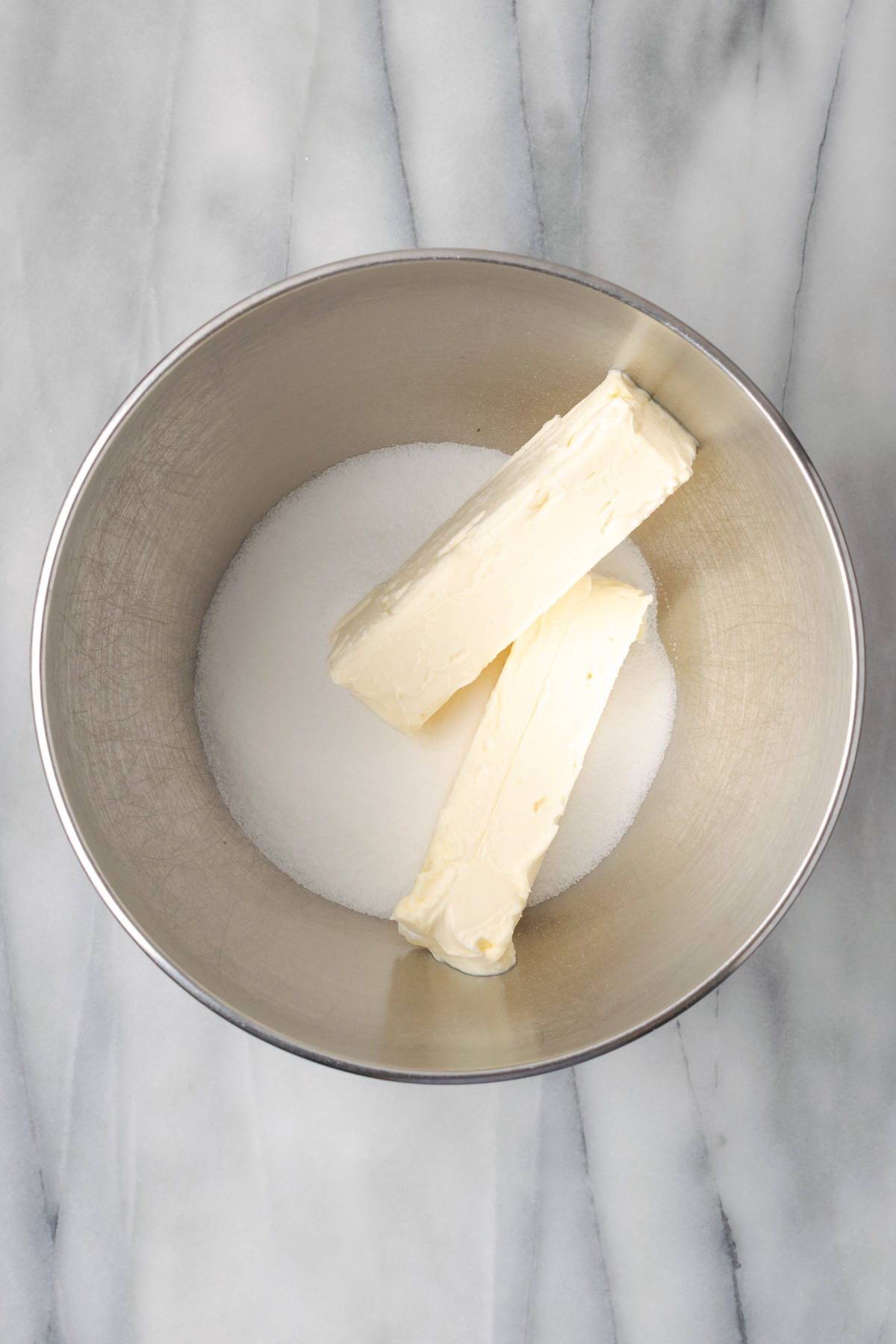 Butter and sugar combined together in a large mixing bowl. 
