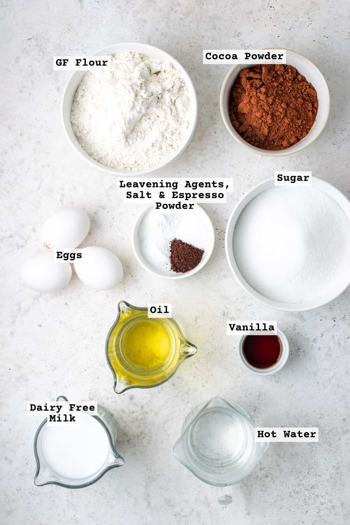 Ingredients for mint chocolate cupcakes on a white table.