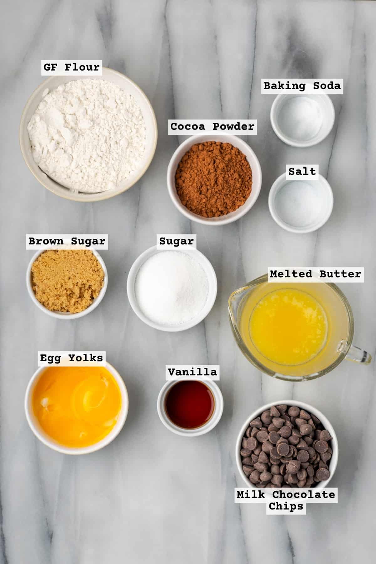 ingredients for a gluten free cookie cake on a white table.