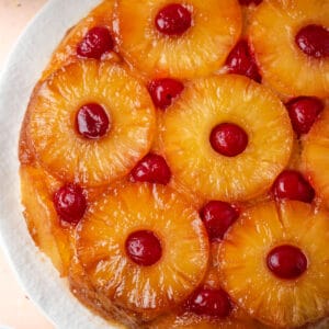 A gluten free pineapple upside down cake served on a white platter.