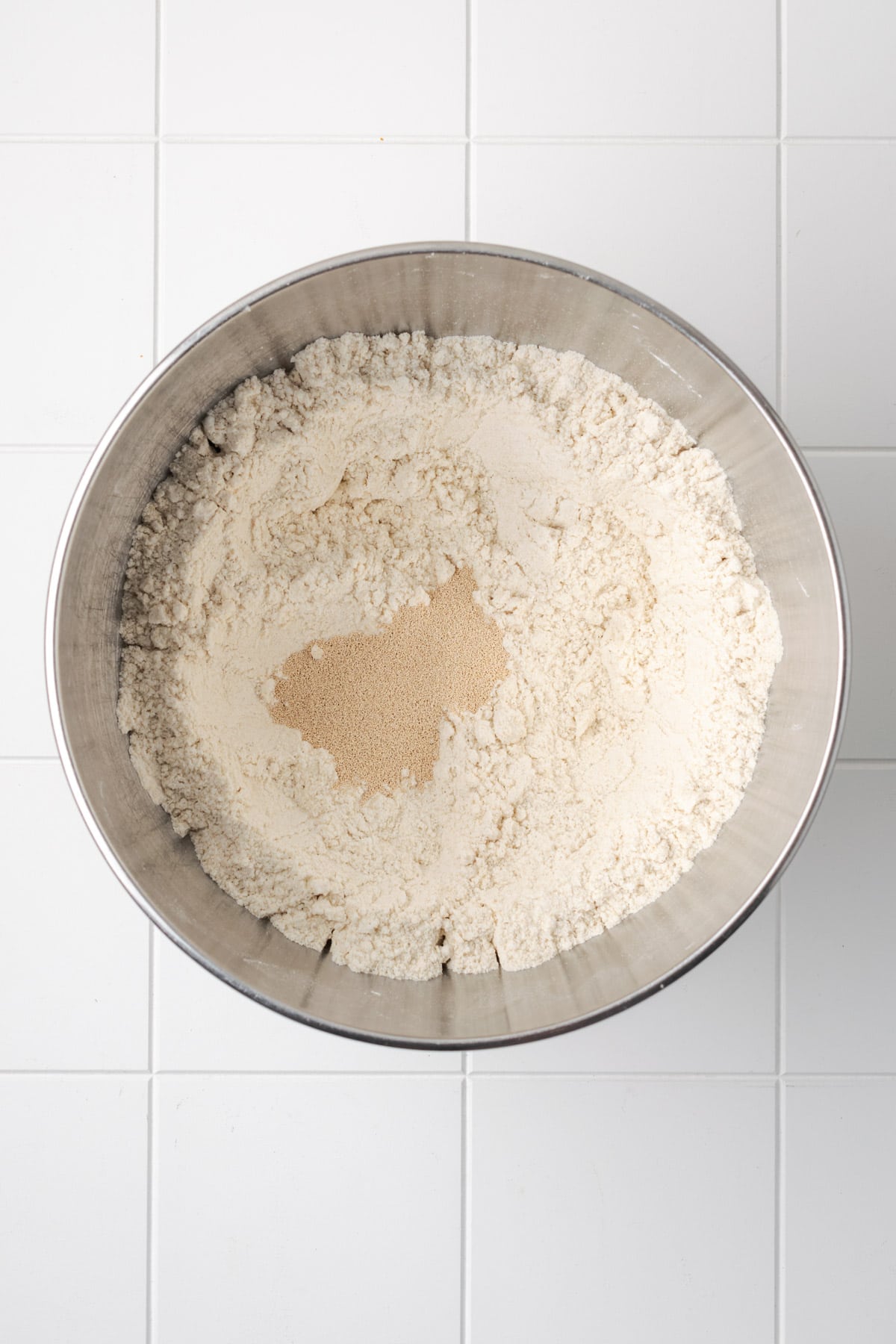 Instant yeast added to the mixing bowl with the dry ingredients.