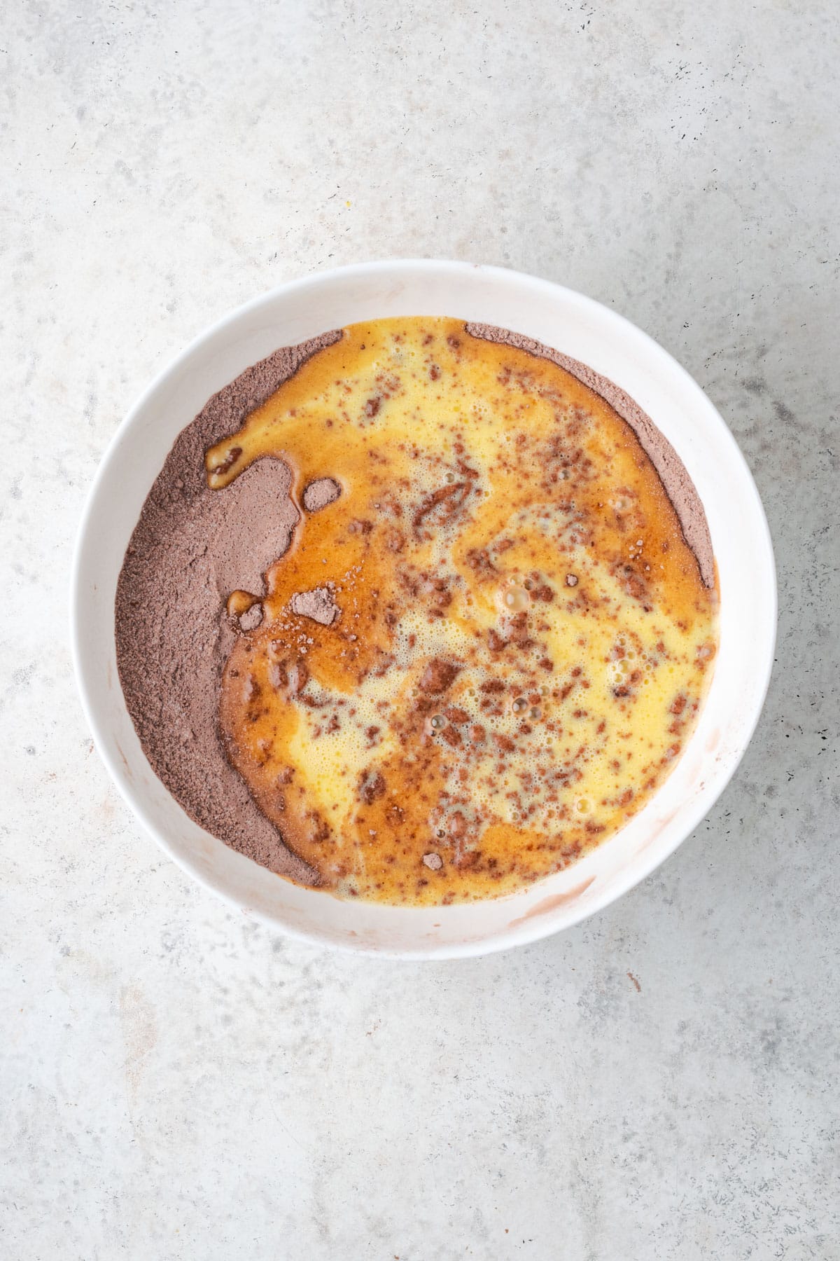 The egg mixture added to the dry ingredients in a large mixing bowl. 