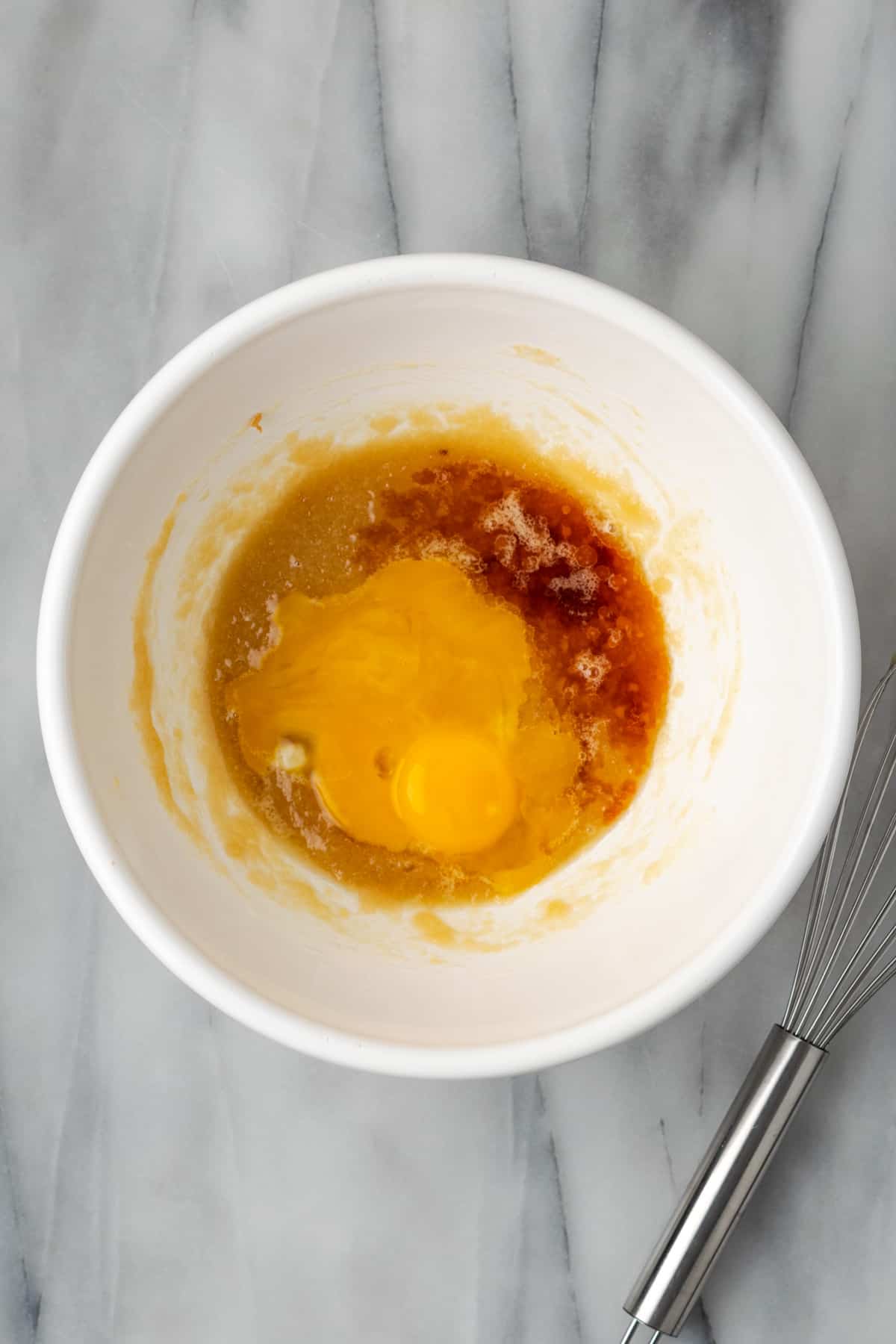 Egg yolks and vanilla added to the butter and sugar mixture in the large mixing bowl. 