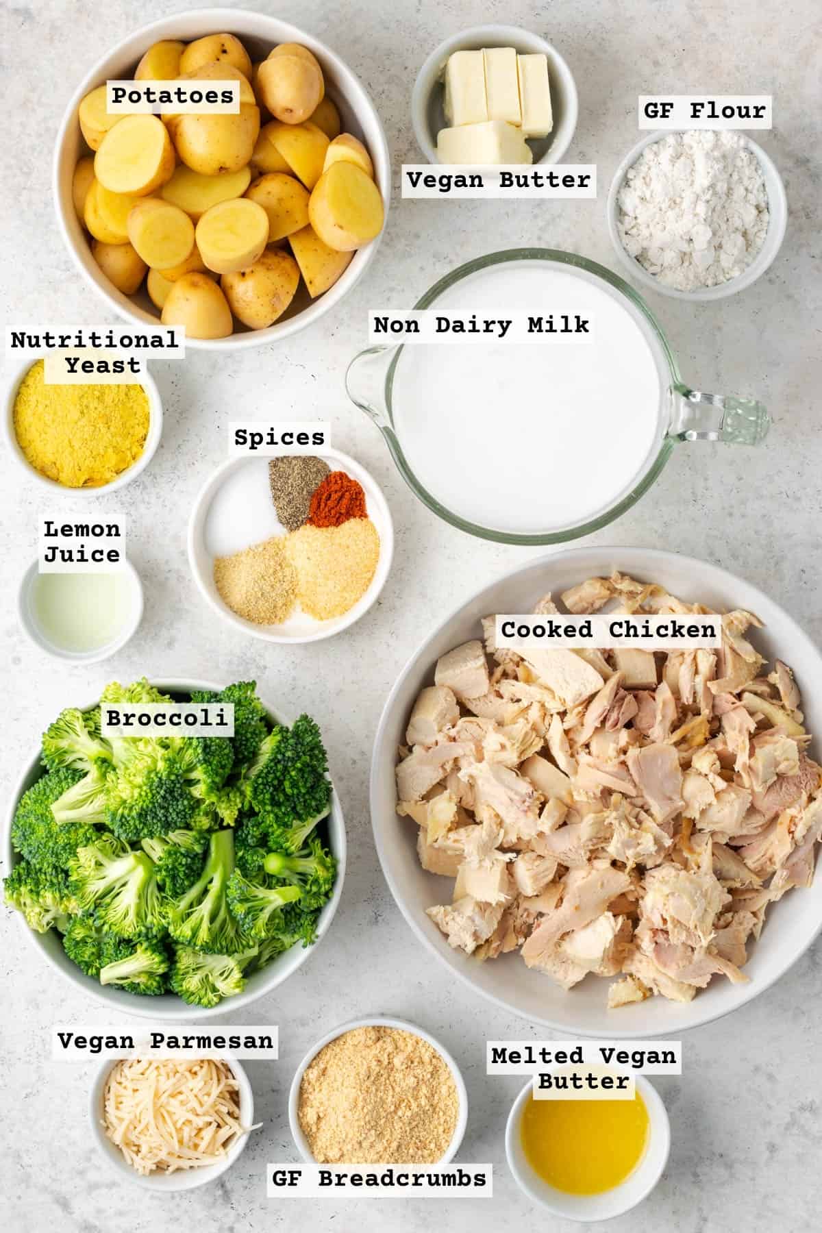 Ingredients for chicken broccoli potato casserole sitting on a white table.