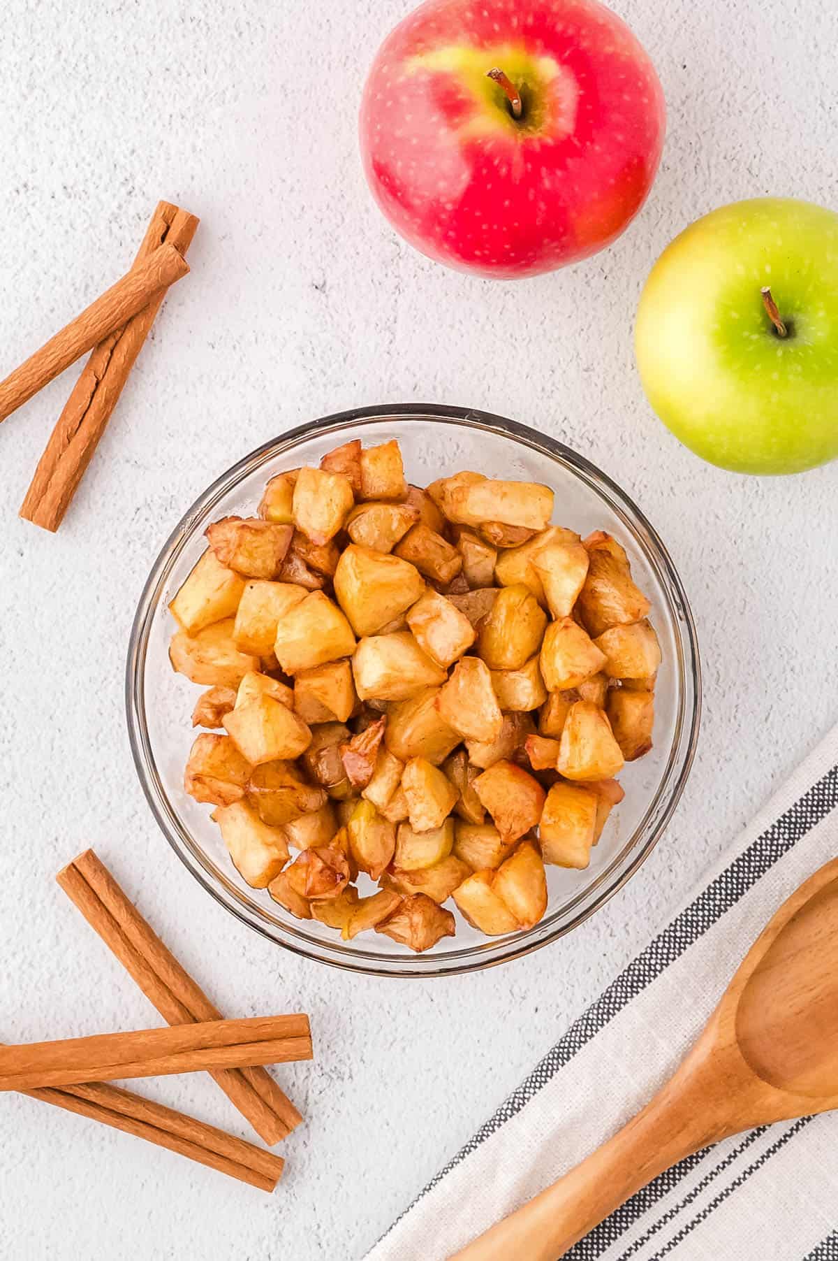 Baked cinnamon apples in a large mixing bowl.