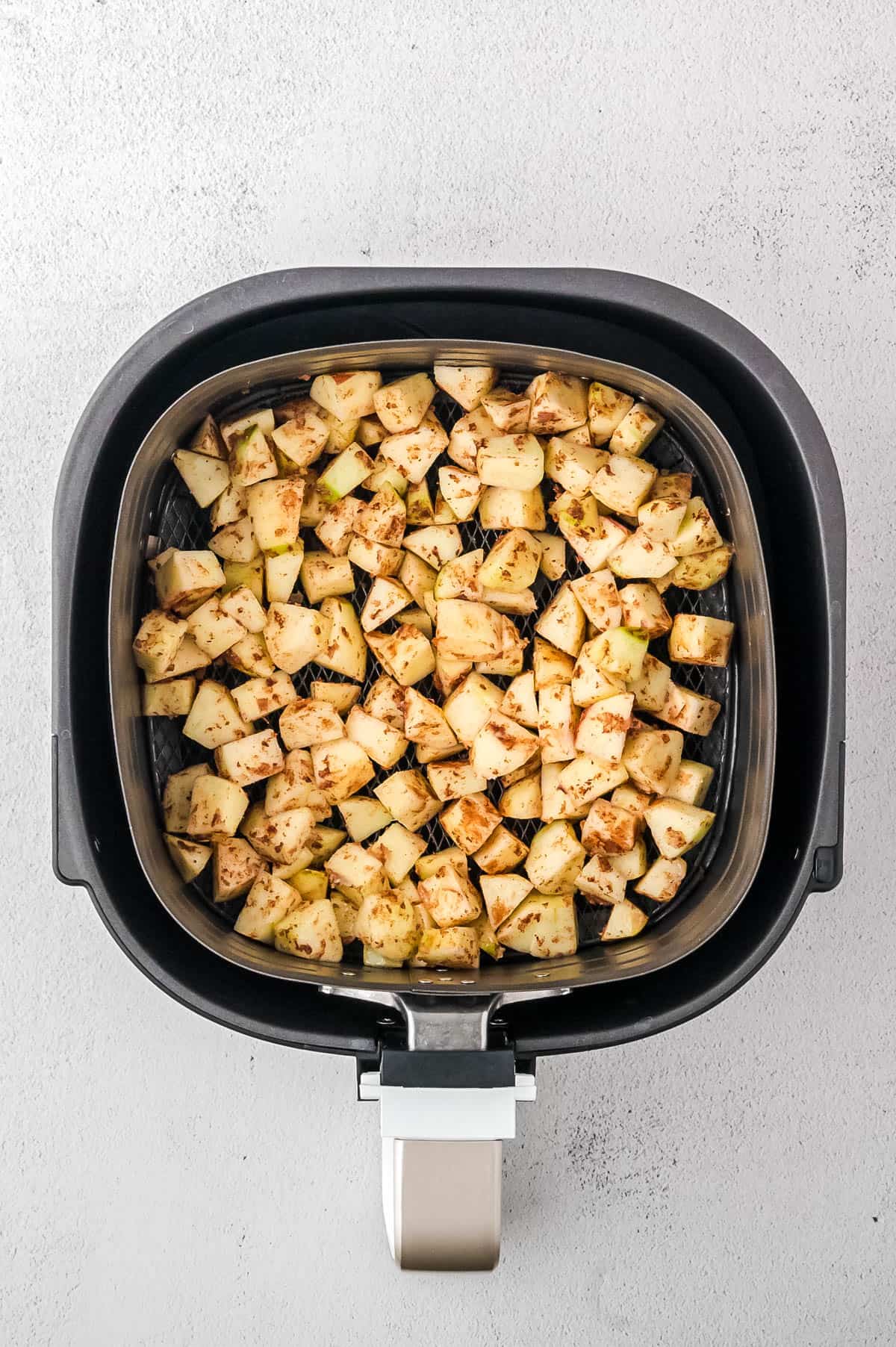 Cinnamon apple pieces in the air fryer.