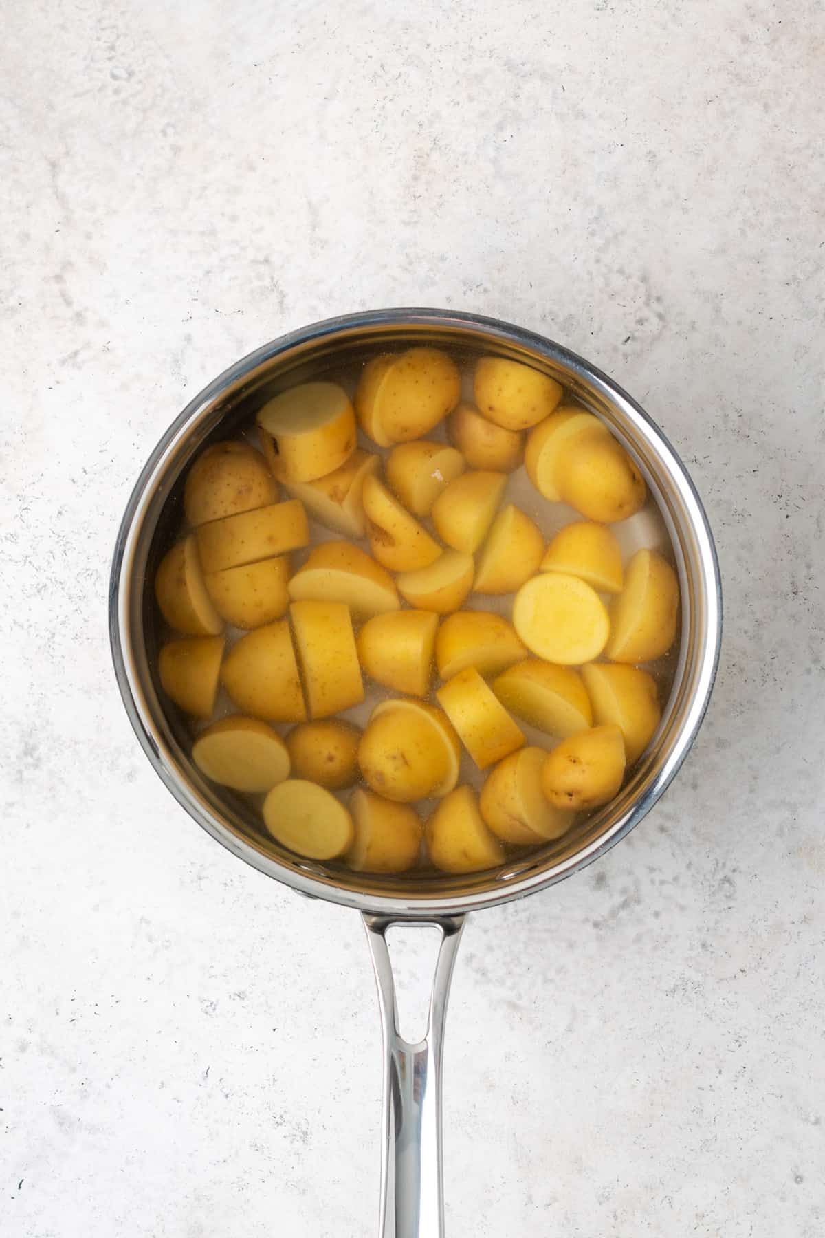 Potatoes placed in a pot of water to boil.