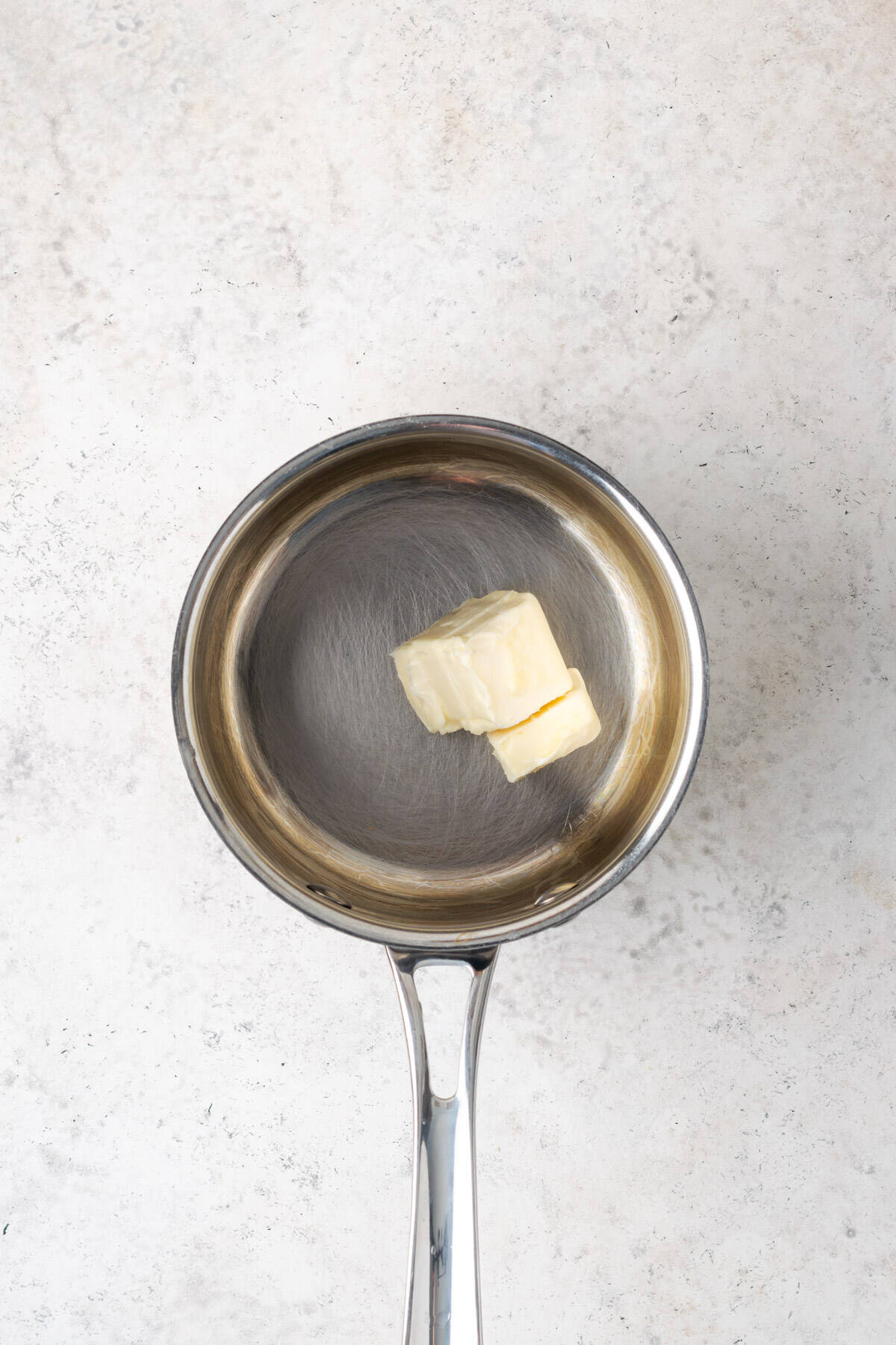 Butter being melted in a small saucepan.