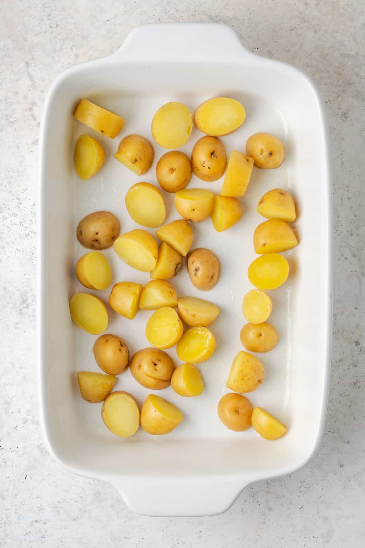 Cooked potatoes in a white casserole dish.