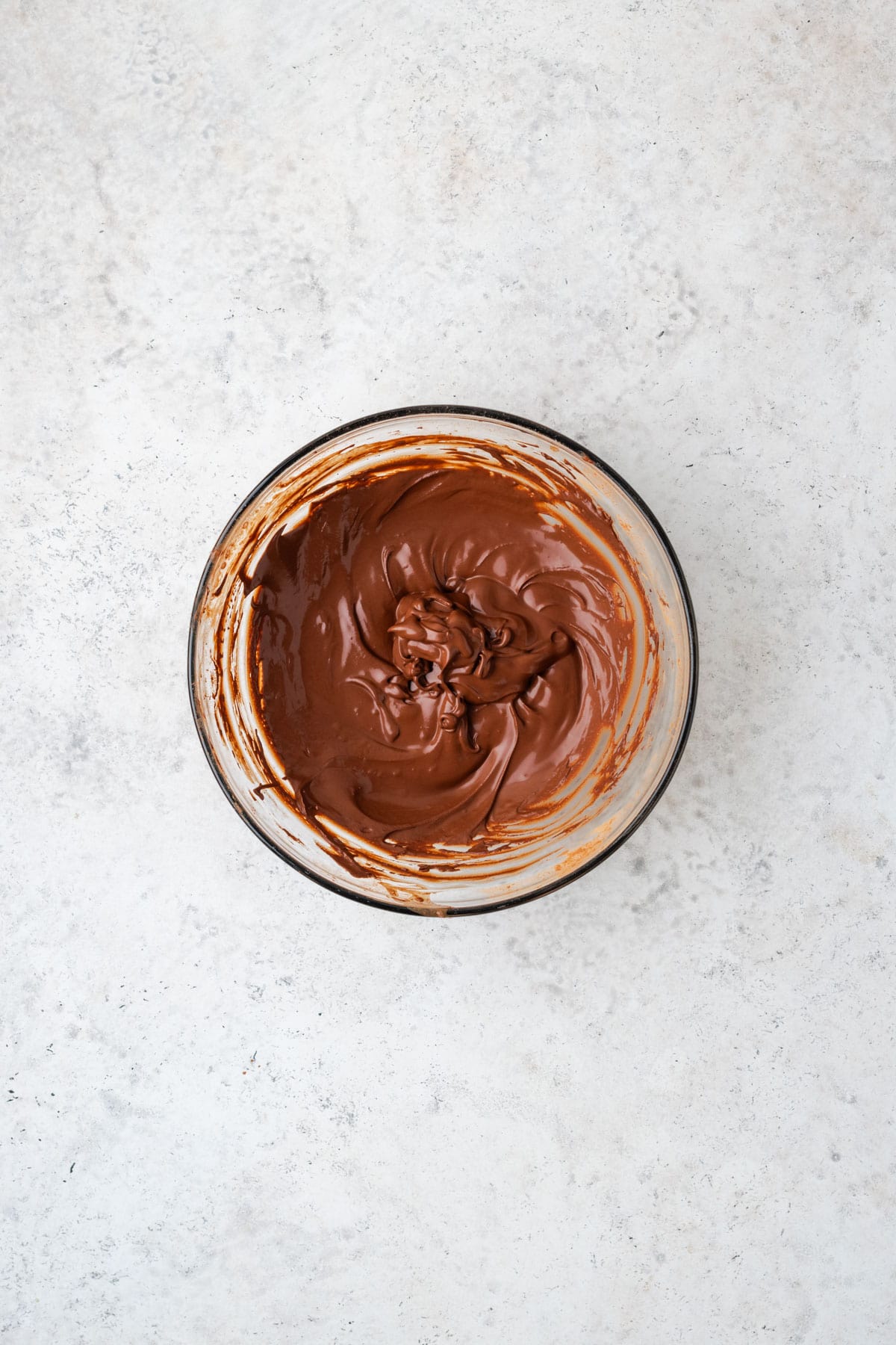 Cocoa powder and water combined together in a small bowl to make a chocolate sauce.