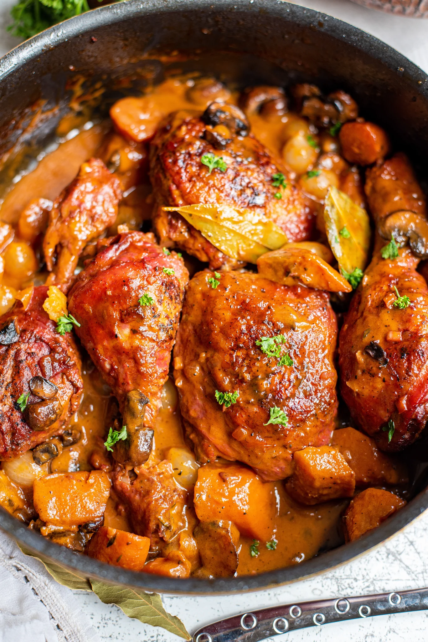 Coq au vin in a large cast iron pot.