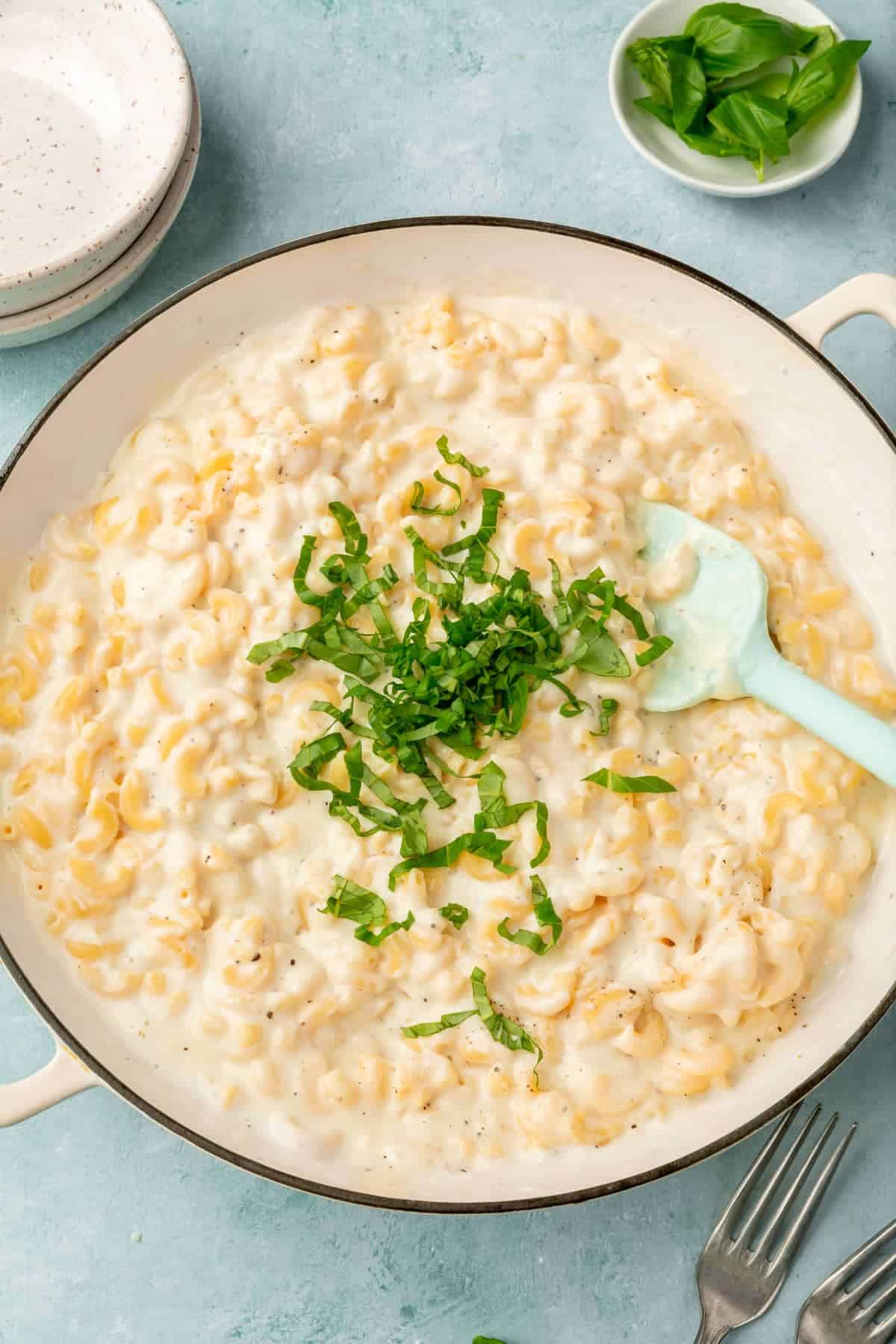 A large pot of mac and cheese on a dinner table.
