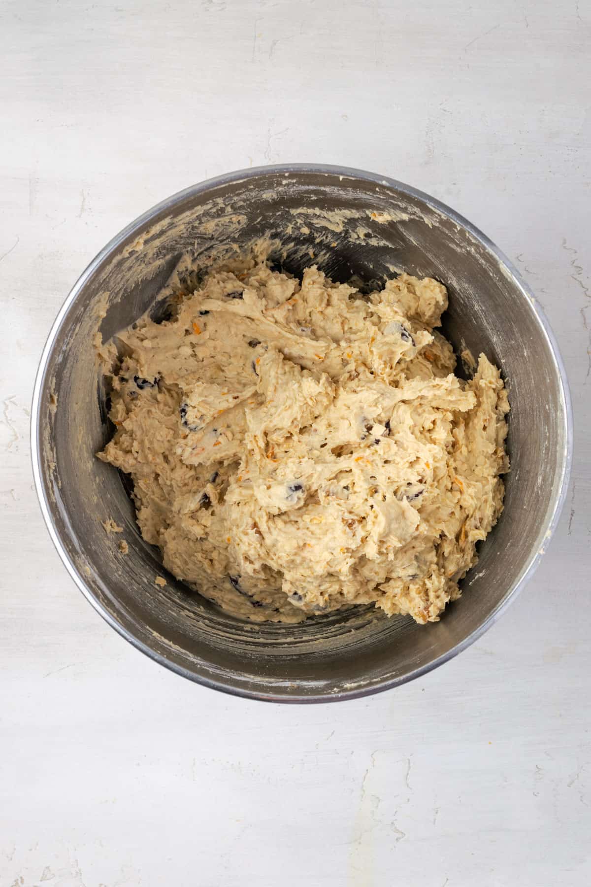 A mixing bowl filled with cranberry orange oatmeal cookie dough. 