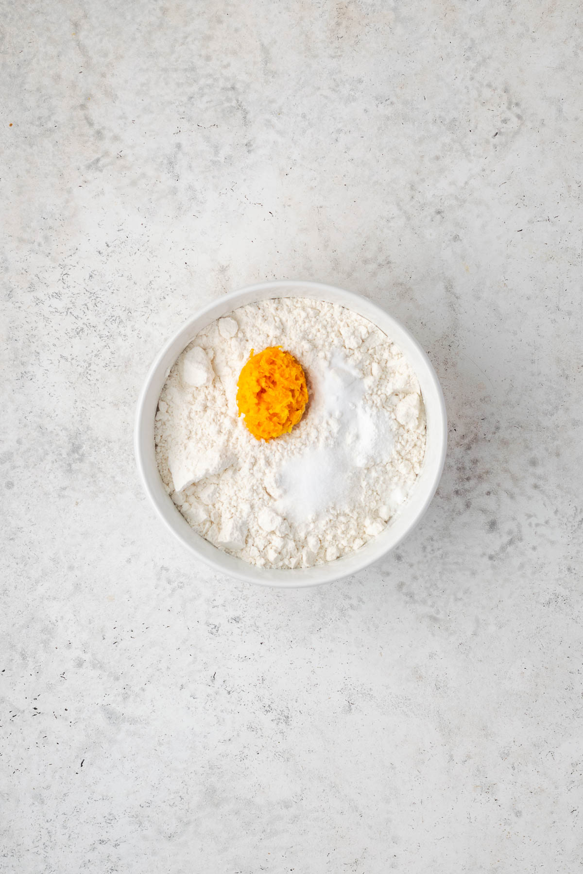 Gluten free flour, orange zest, baking powder, baking soda, and salt combined in a small bowl.