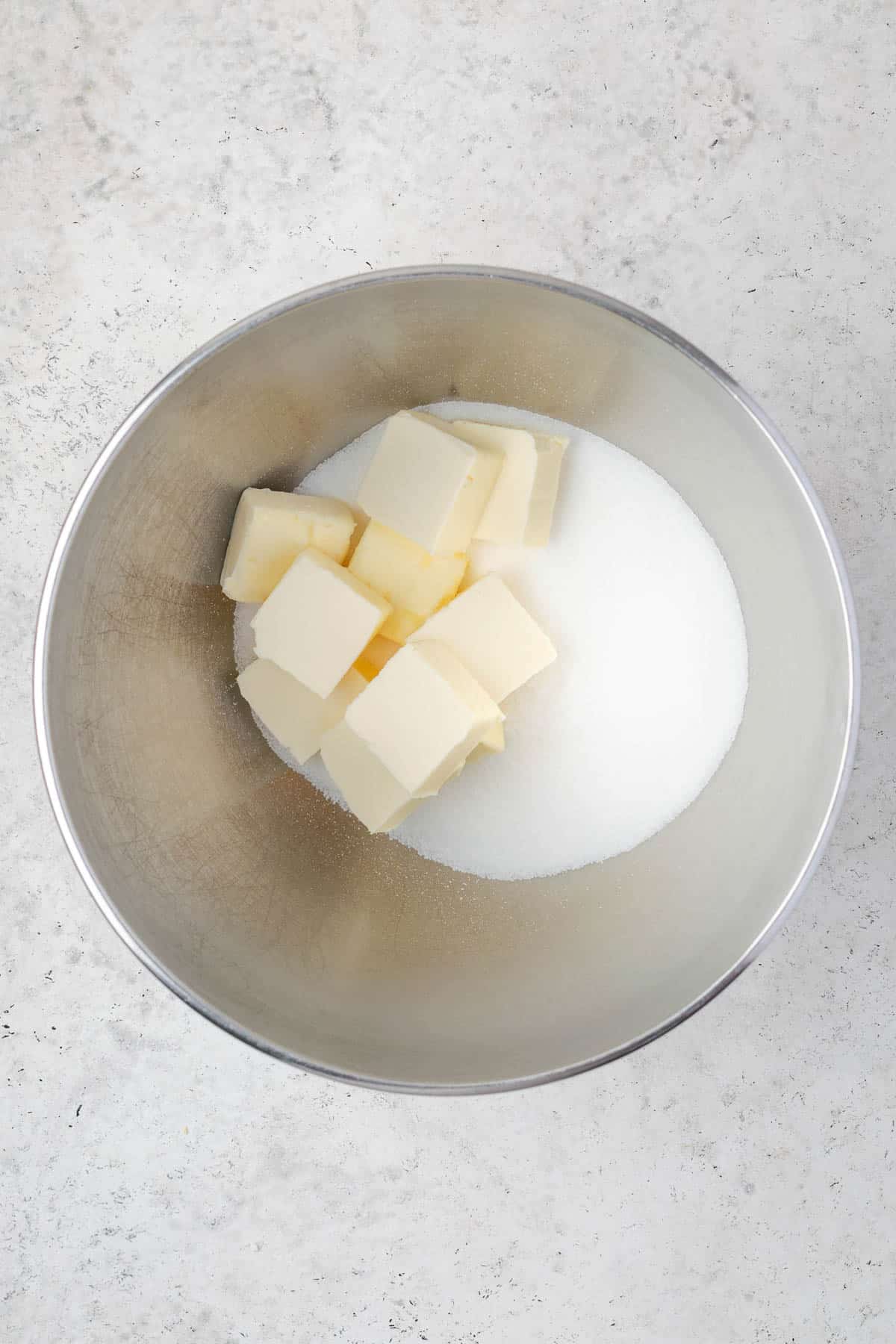 Butter and sugar in a large metal mixing bowl. 