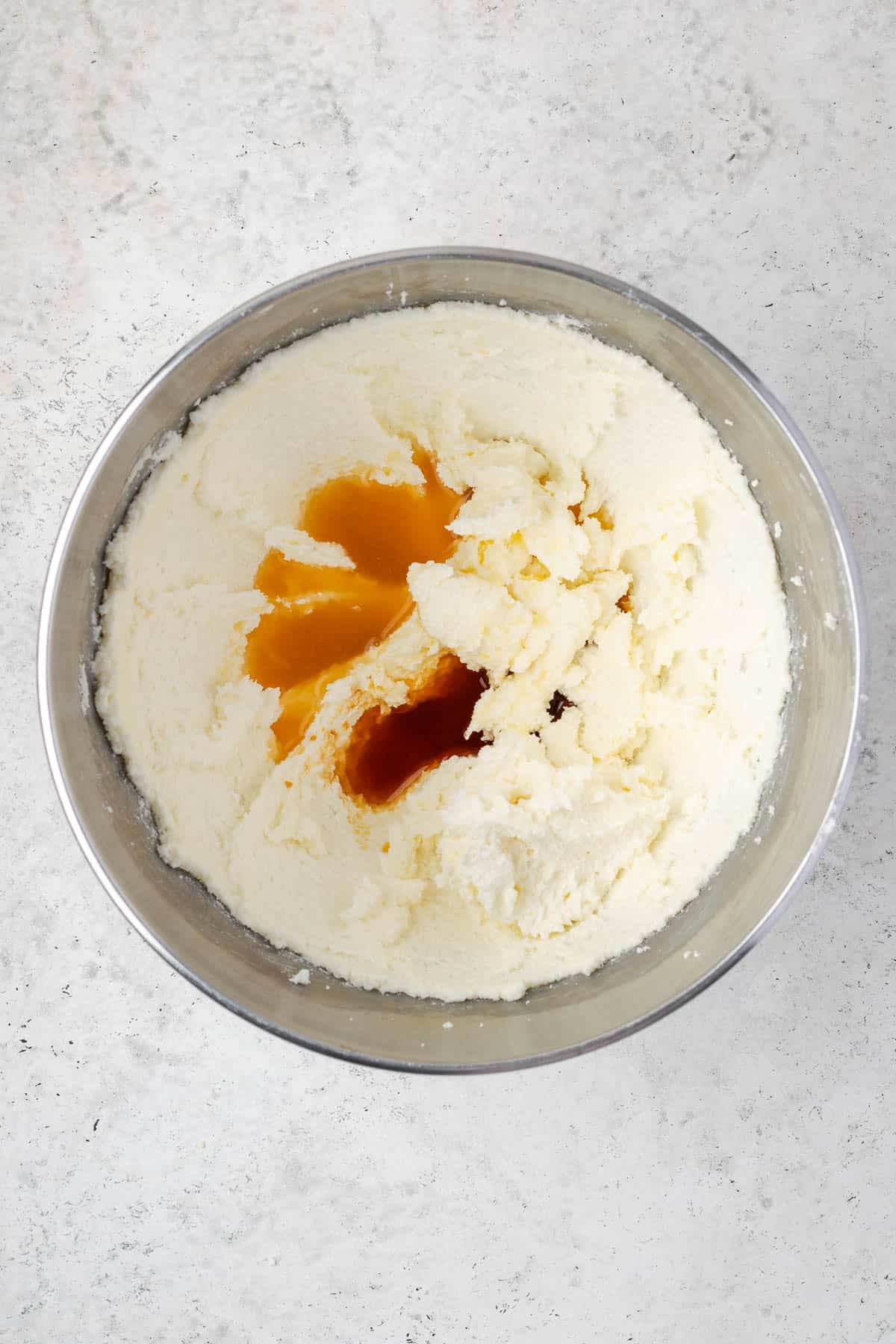 Orange juice and vanilla extract added to the beaten sugar and butter mixture.