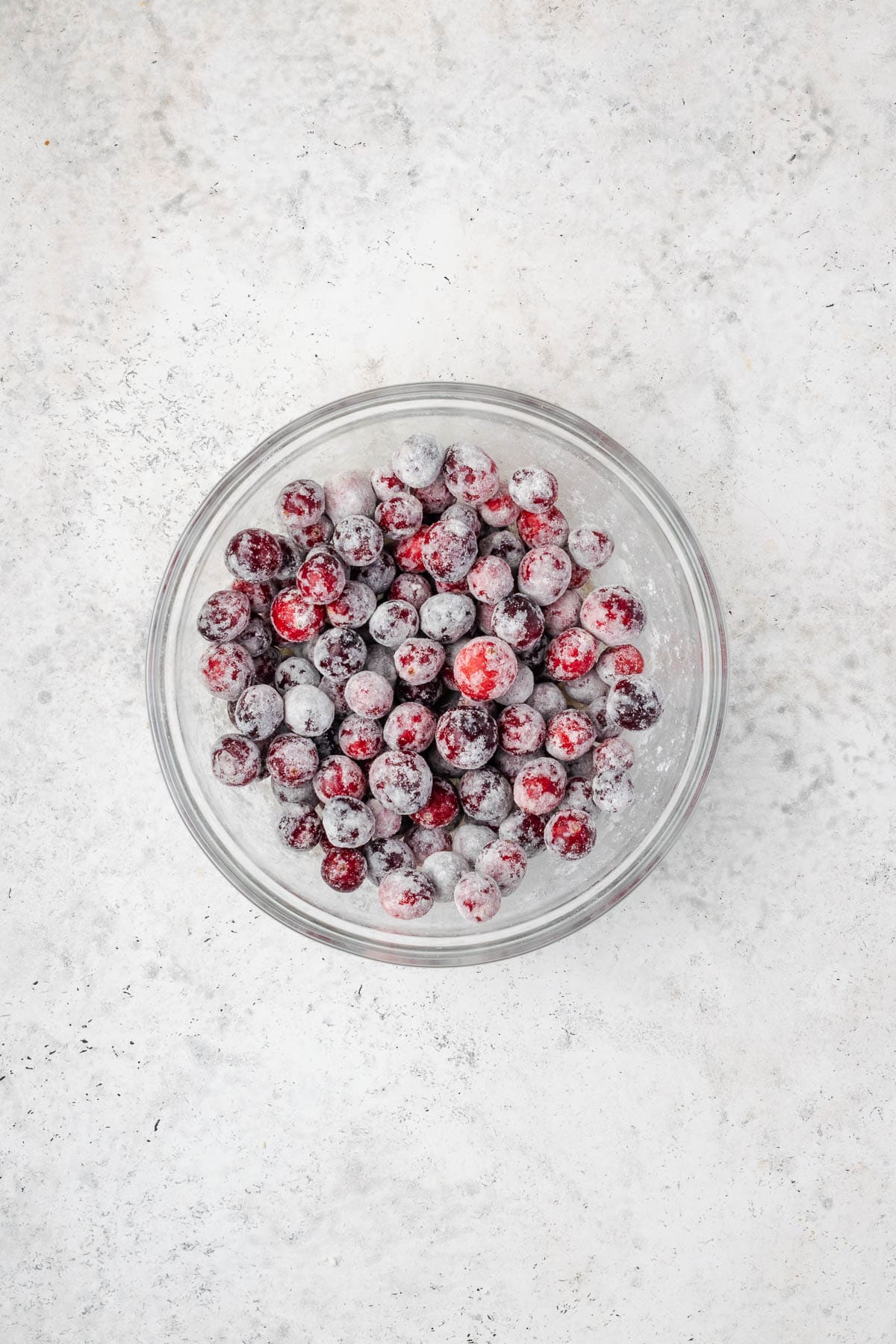 Cranberries coated with flour in a small bowl.