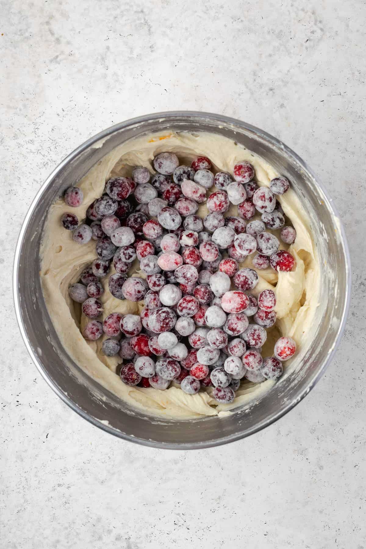 Flour coated cranberries added to the mixing bowl with the cake batter.