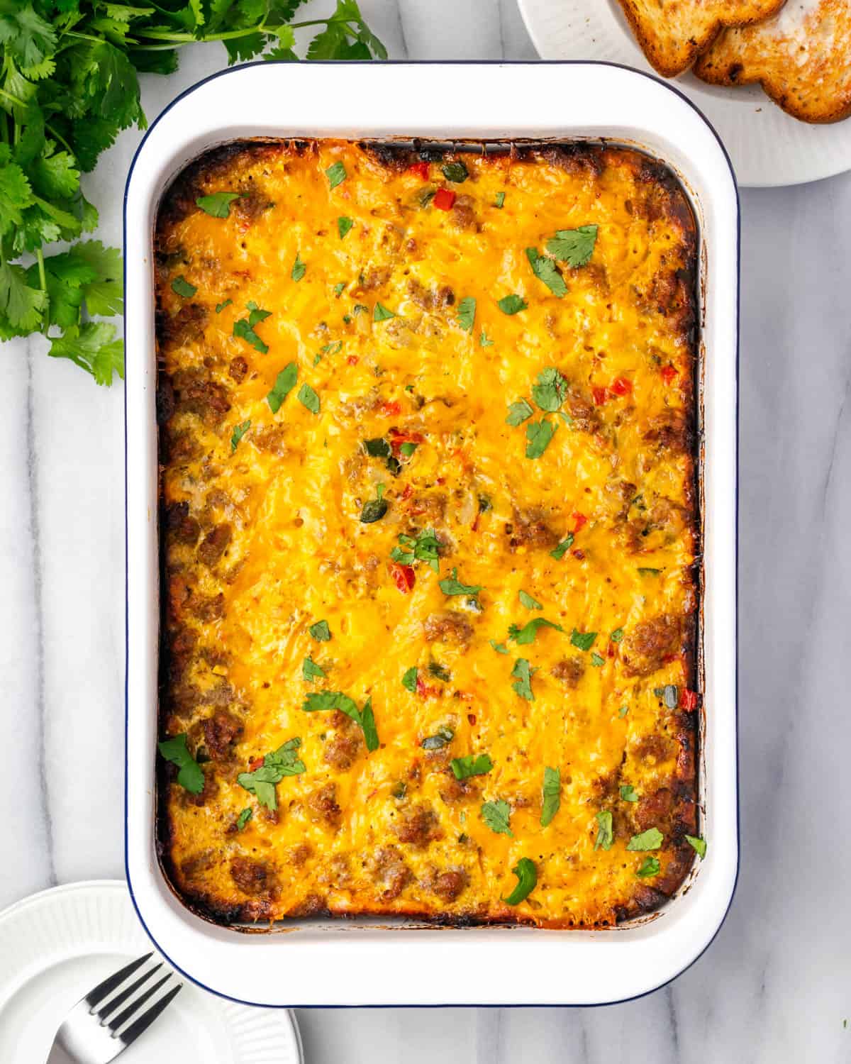 A freshly baked Mexican breakfast casserole sitting on a marble countertop. 