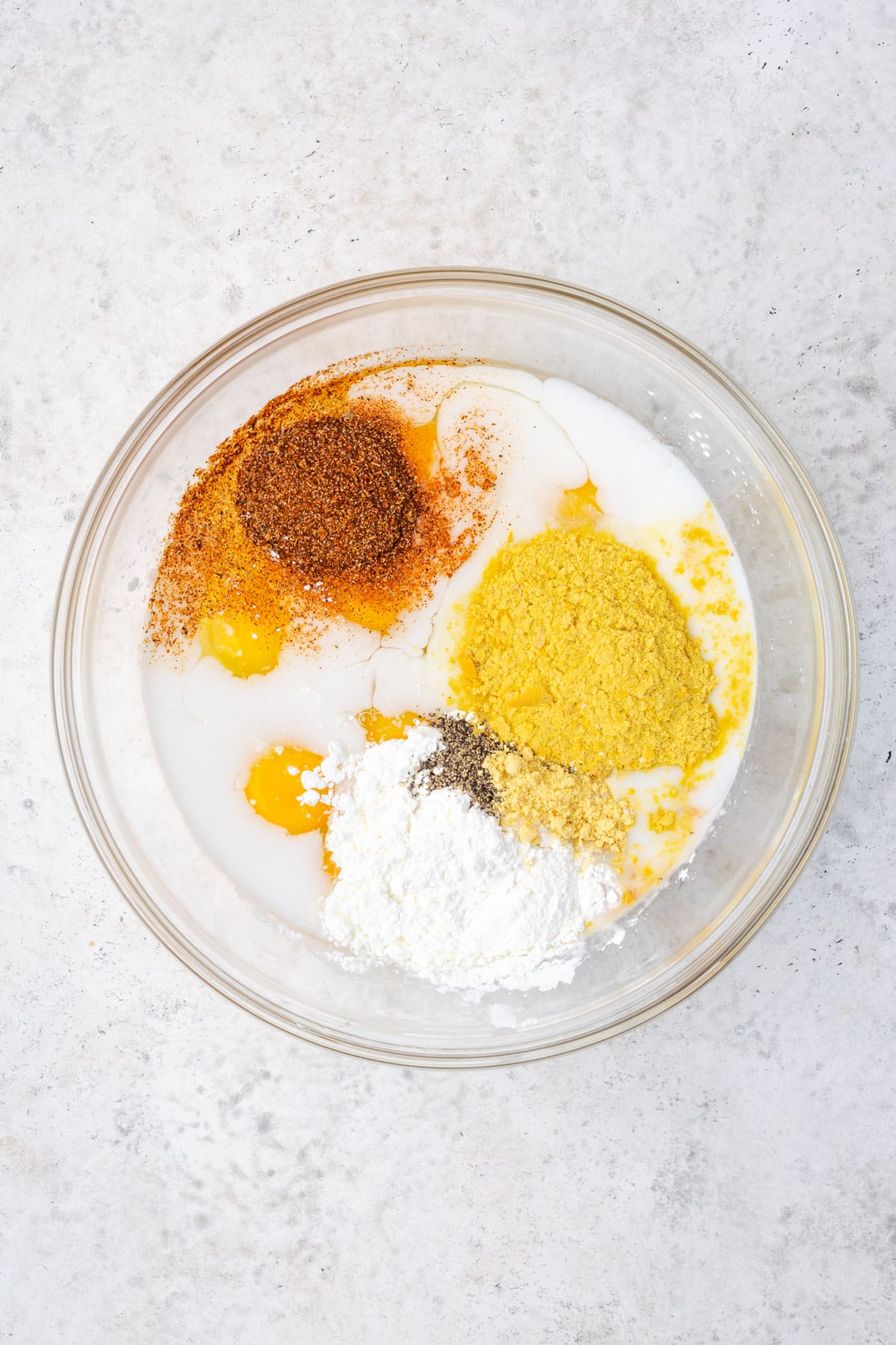 Eggs, milk, salsa, cornstarch, nutritional yeast, salt, black pepper and dry mustard combined in a large mixing bowl. 