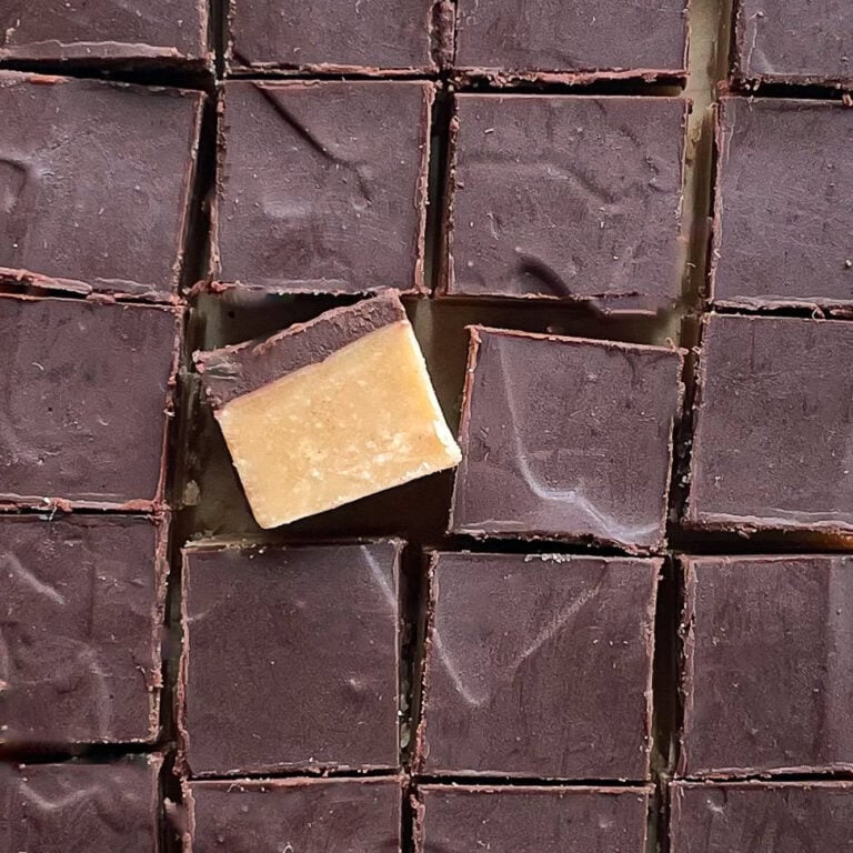 A batch of chocolate peanut butter fudge cut into small squares.