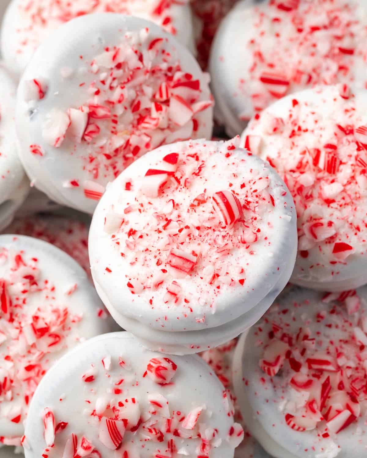 Peppermint bark covered Oreos laying on a serving tray.