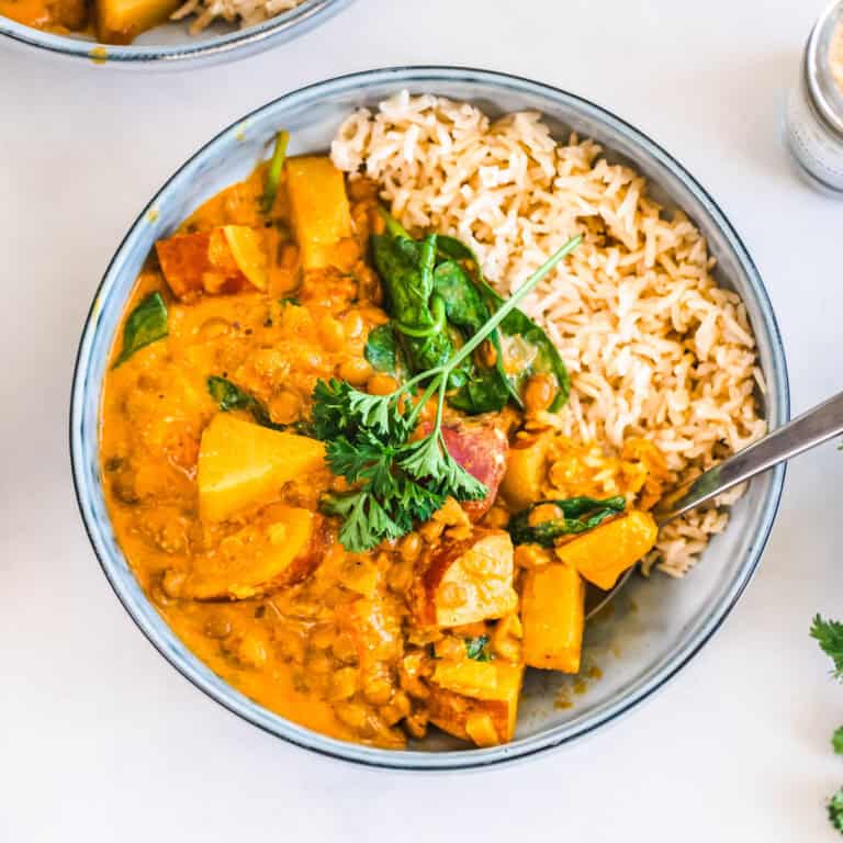 A bowl of lentil curry served over brown rice.